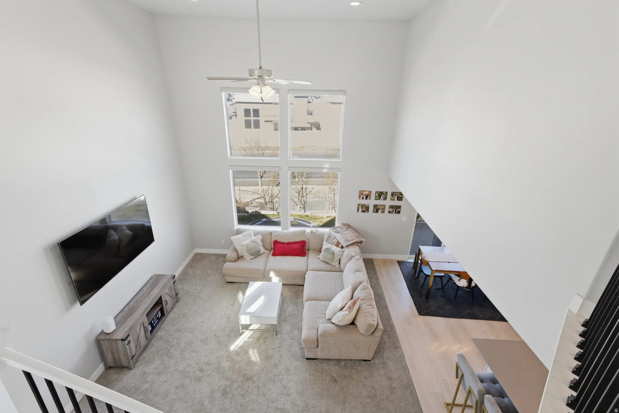 Living room featuring a high ceiling and ceiling fan