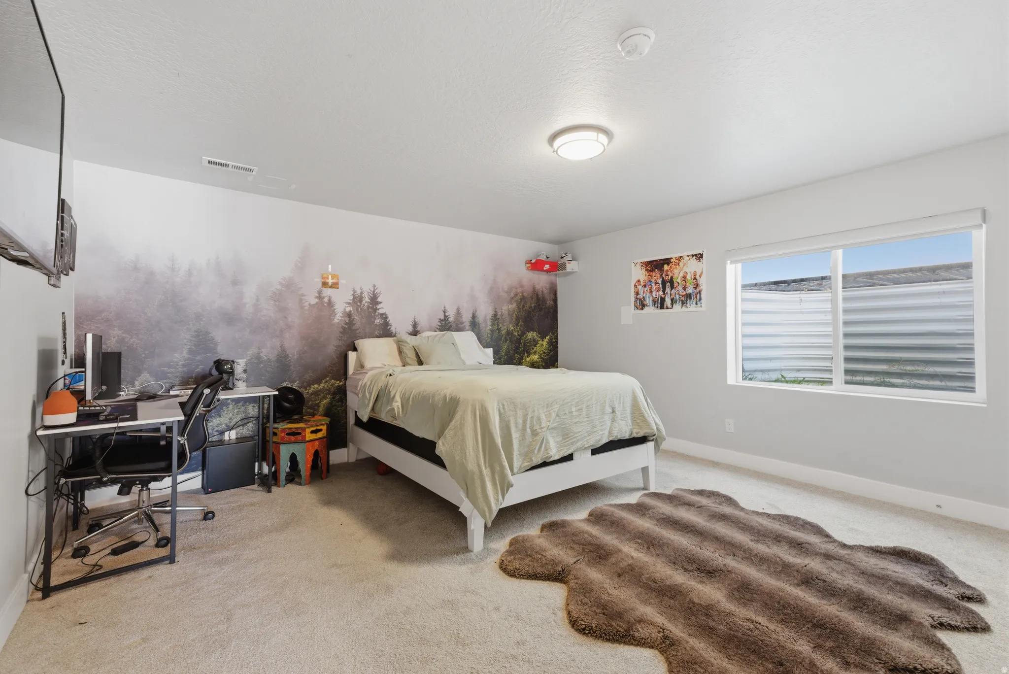 Bedroom featuring a desk and light colored carpet