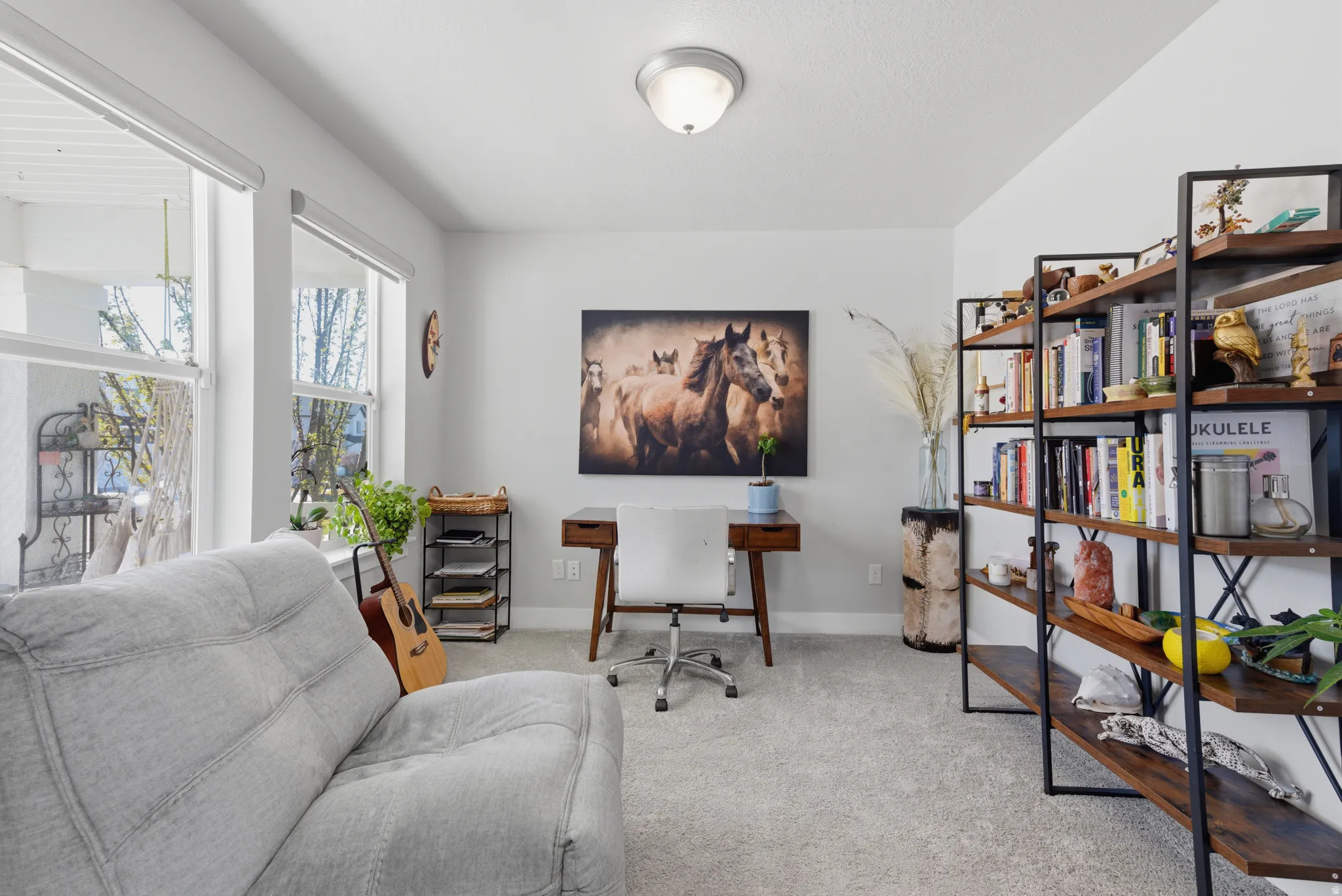 Home office featuring light colored carpet and baseboards
