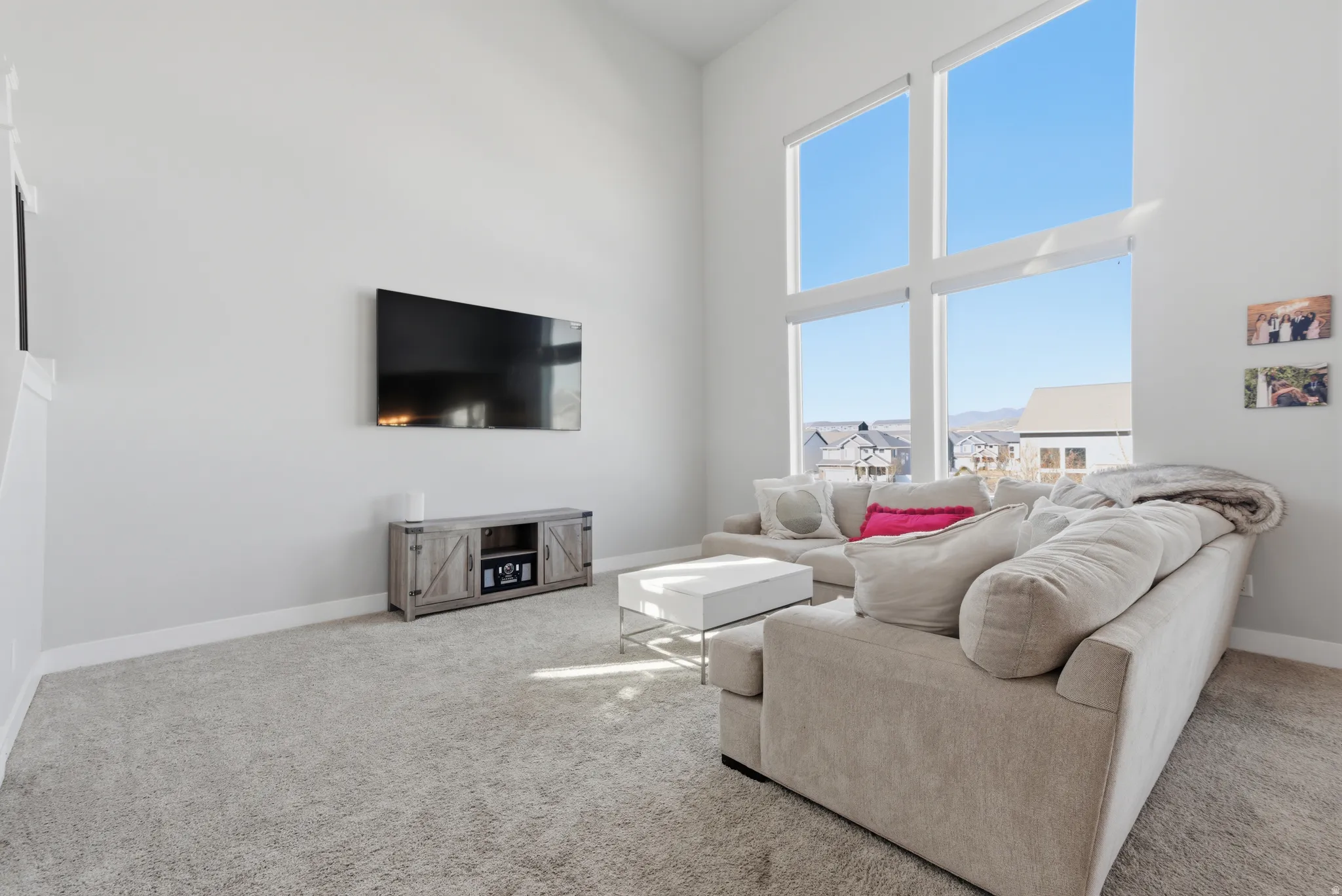 Living room featuring carpet floors and a high ceiling