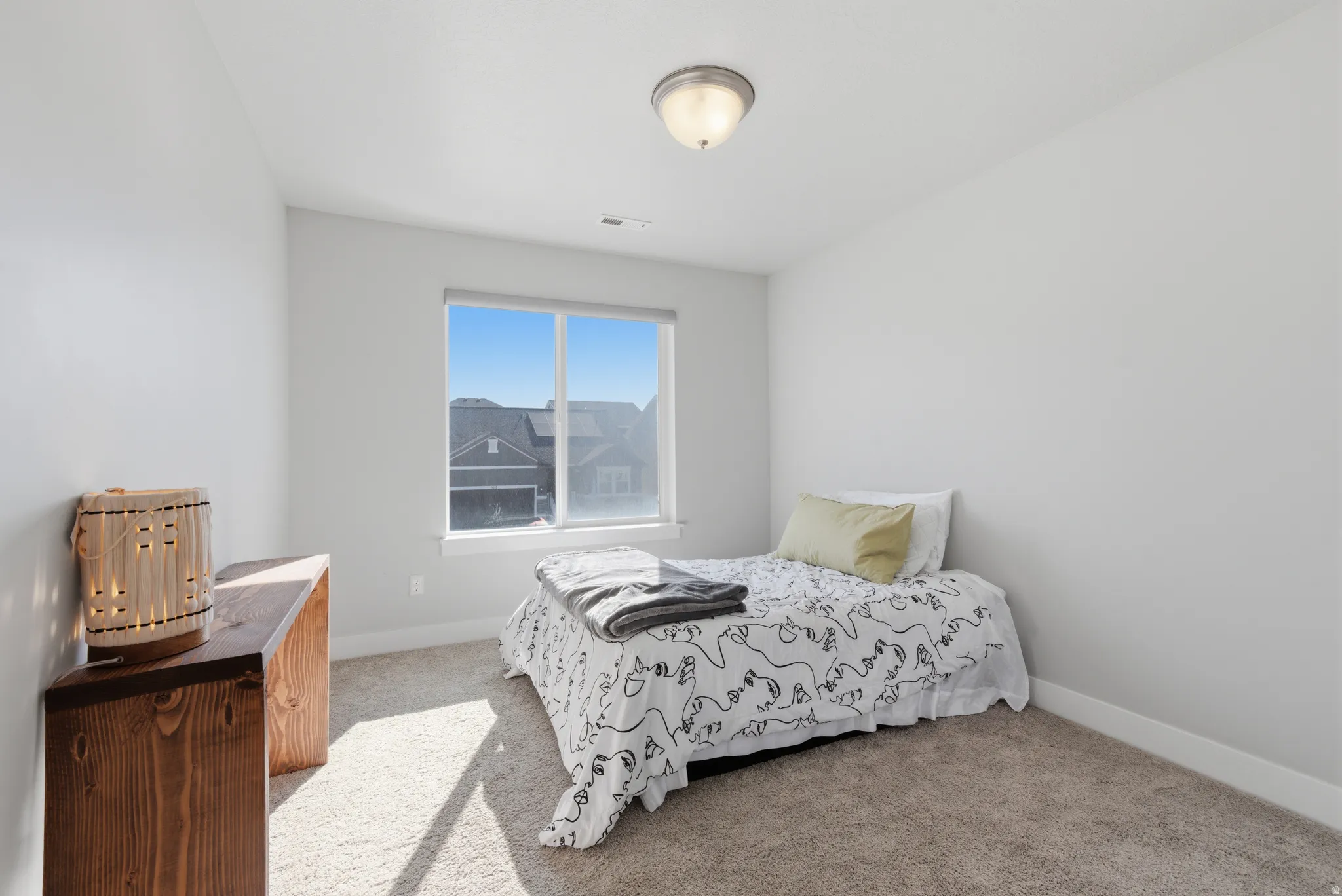 Bedroom with light carpet and baseboards