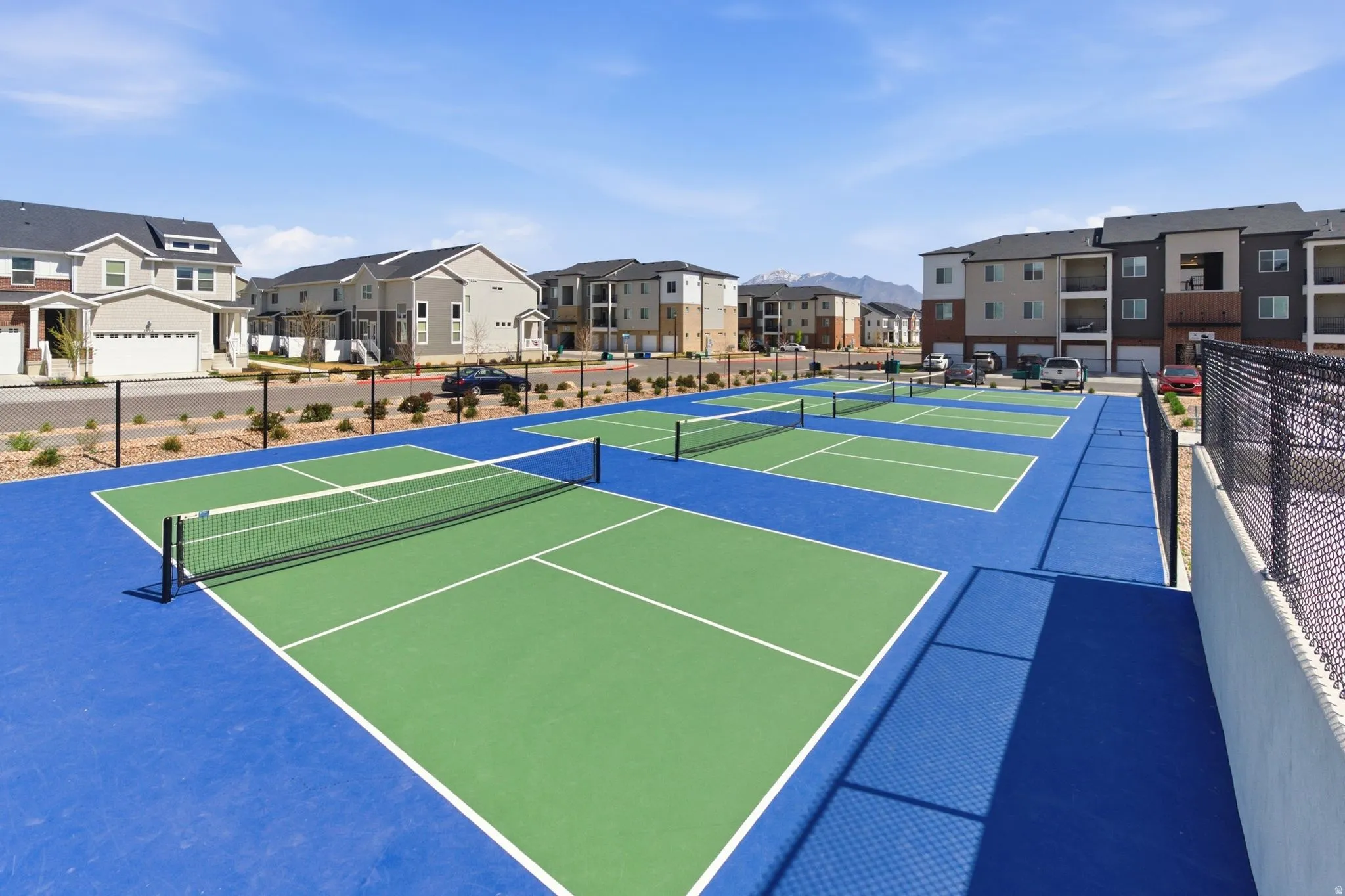 View of tennis court featuring a residential view