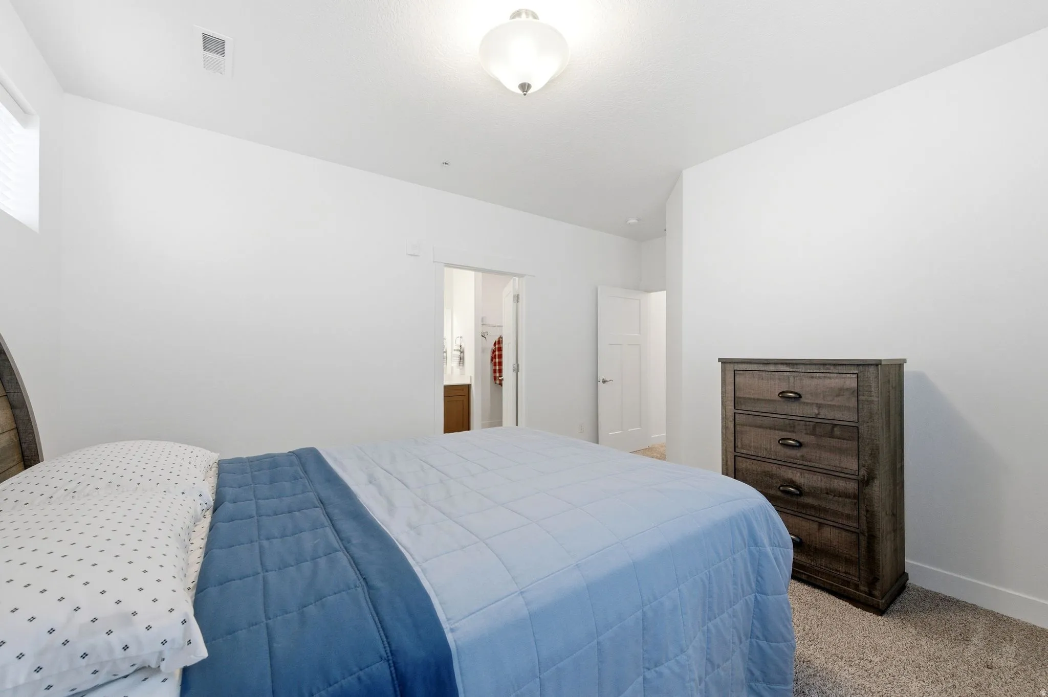 Bedroom featuring light colored carpet and baseboards