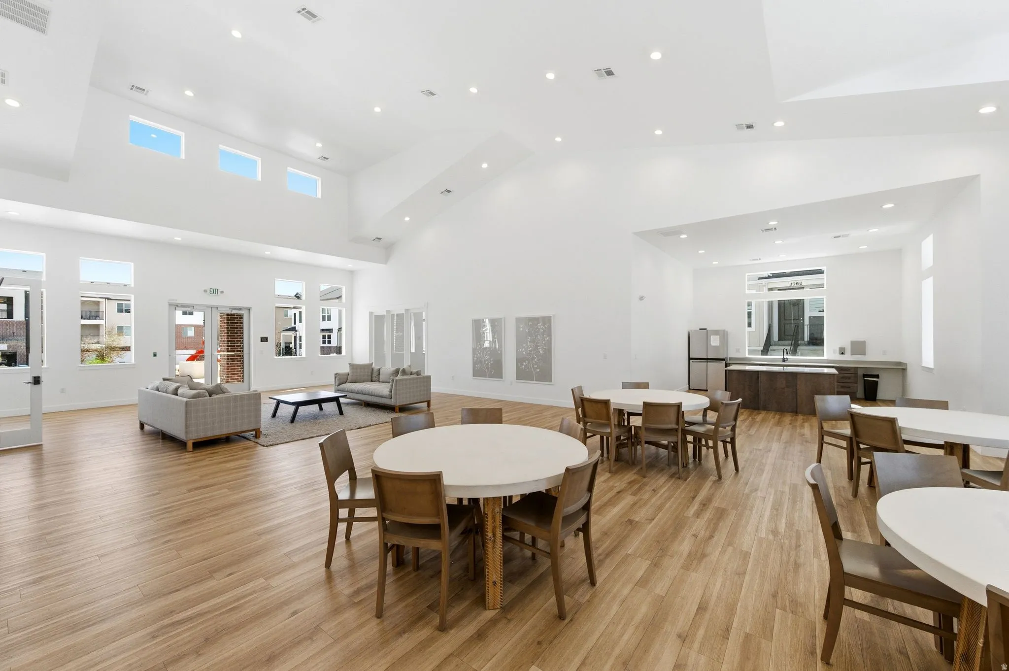 Dining space with recessed lighting, light wood finished floors, and a high ceiling
