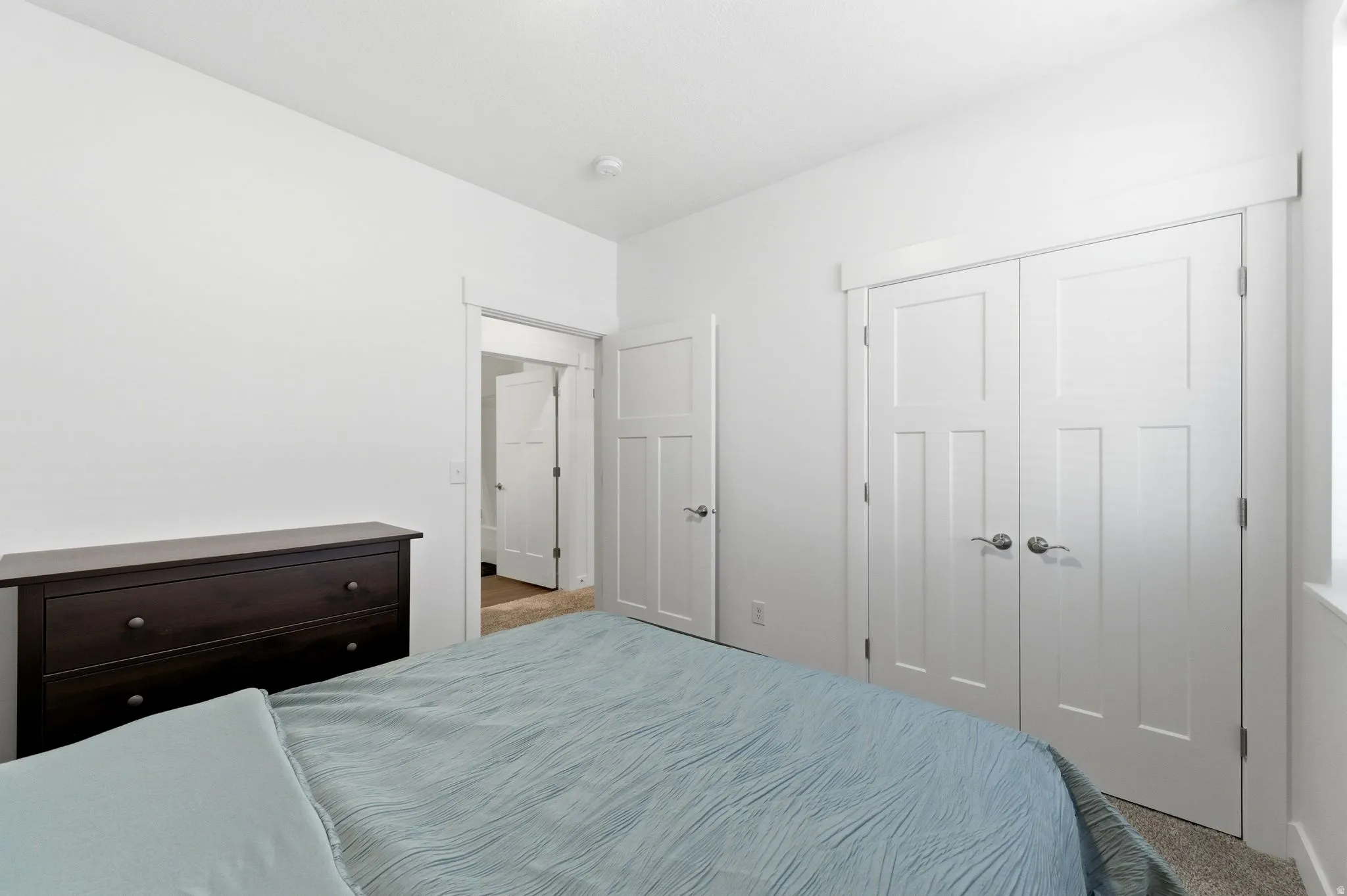 Bedroom with carpet and a closet
