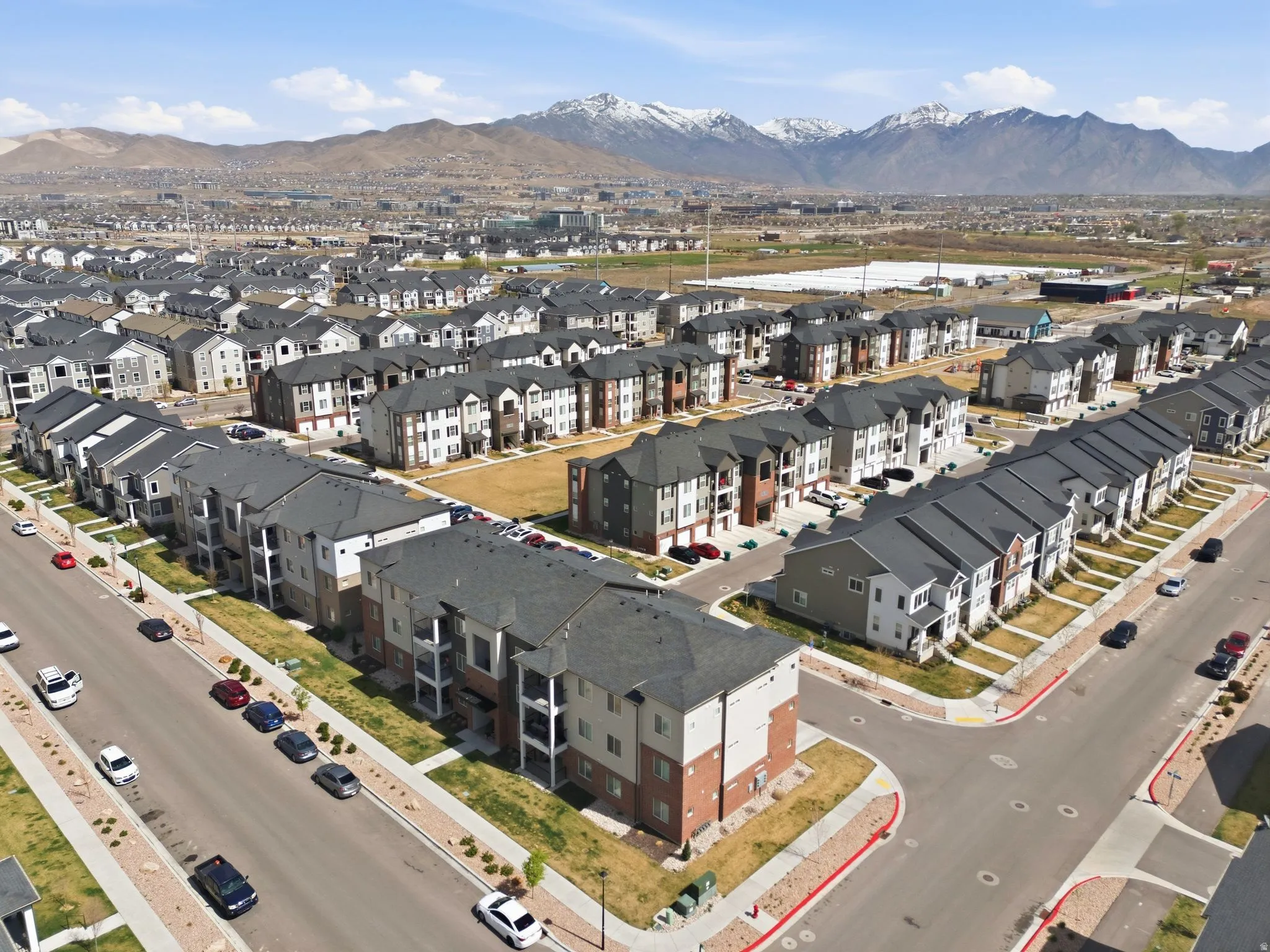 Aerial overview of property's location with mountains and nearby suburban area