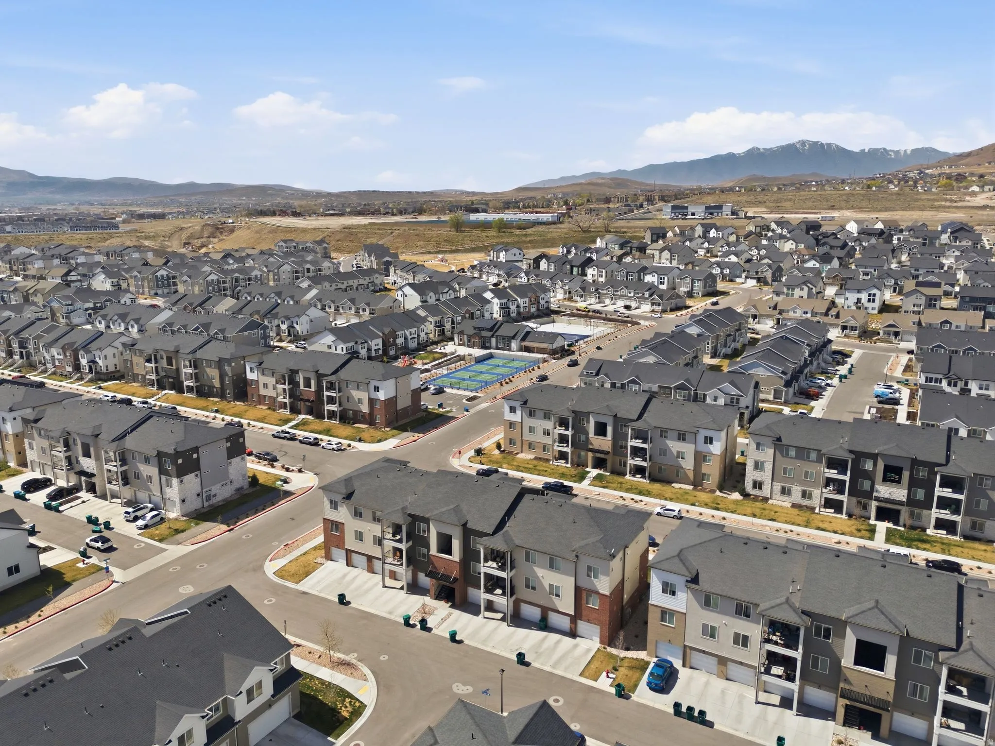 Aerial view of property and surrounding area with a mountain backdrop and nearby suburban area