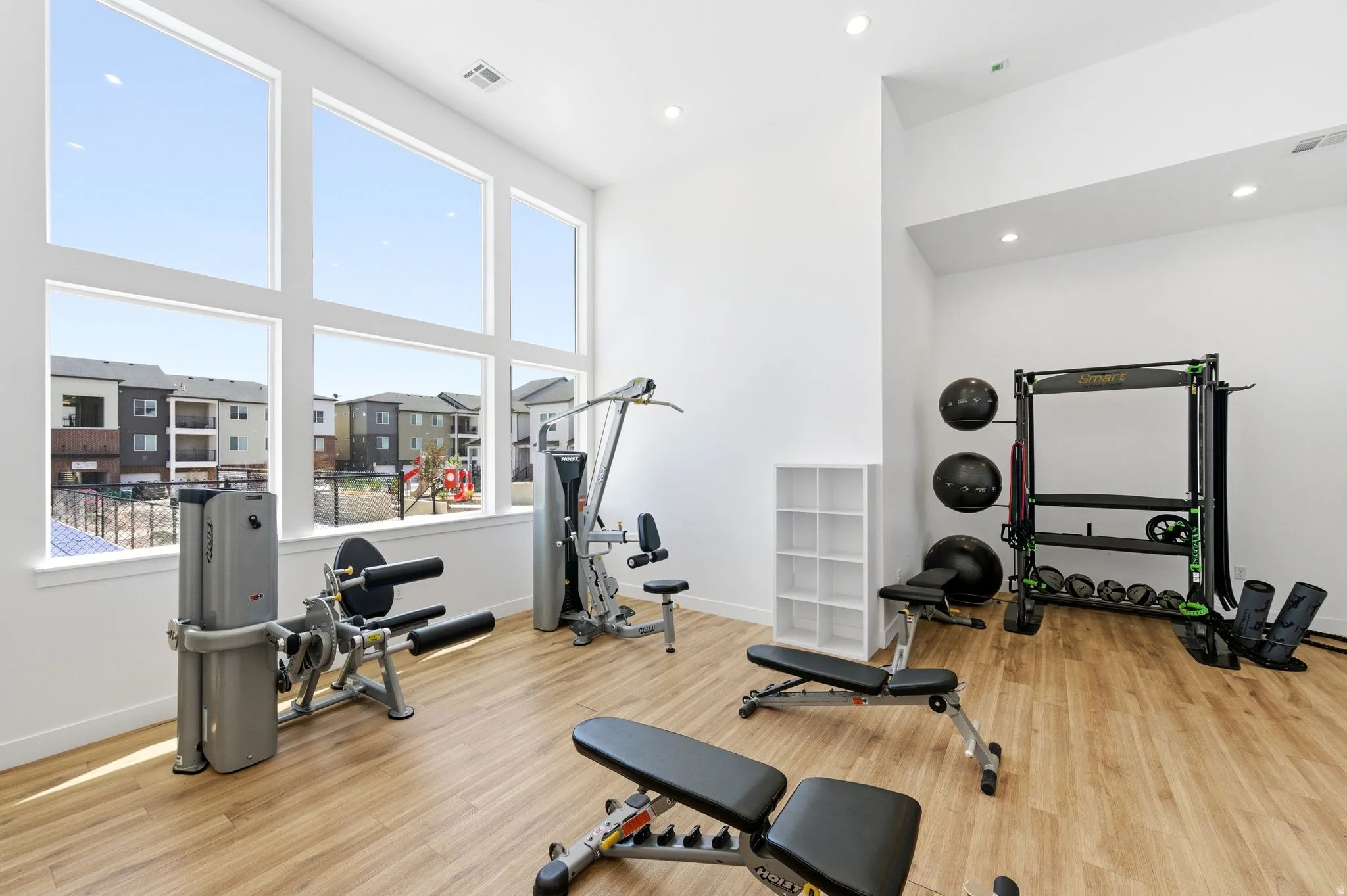 Exercise room featuring a high ceiling and recessed lighting
