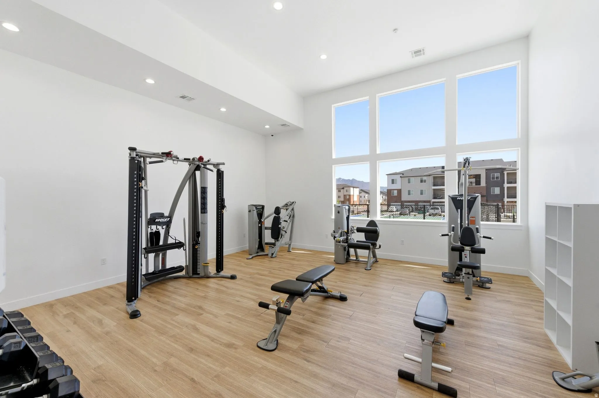 Exercise area featuring a high ceiling and recessed lighting