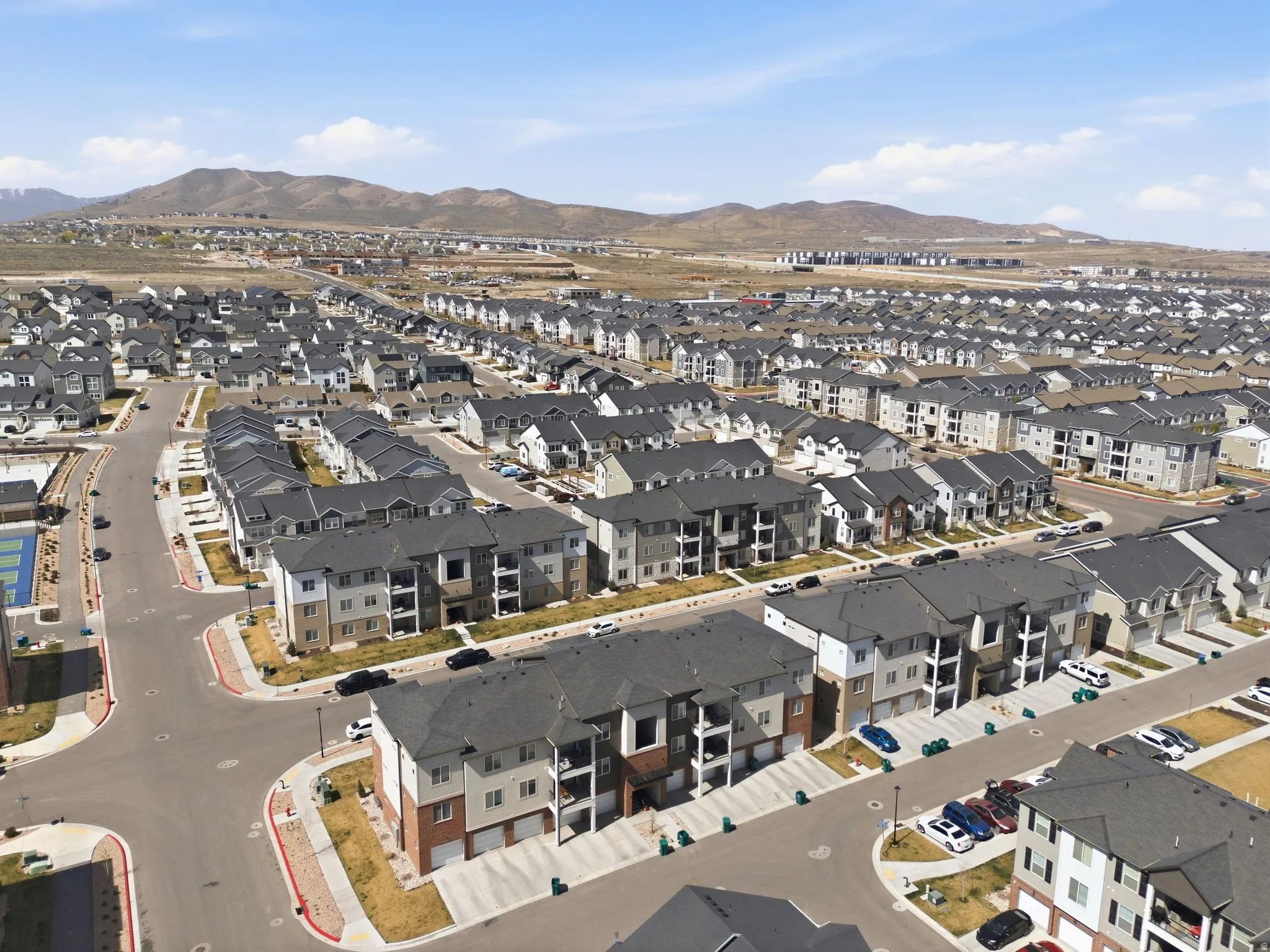 Aerial view of property and surrounding area with nearby suburban area