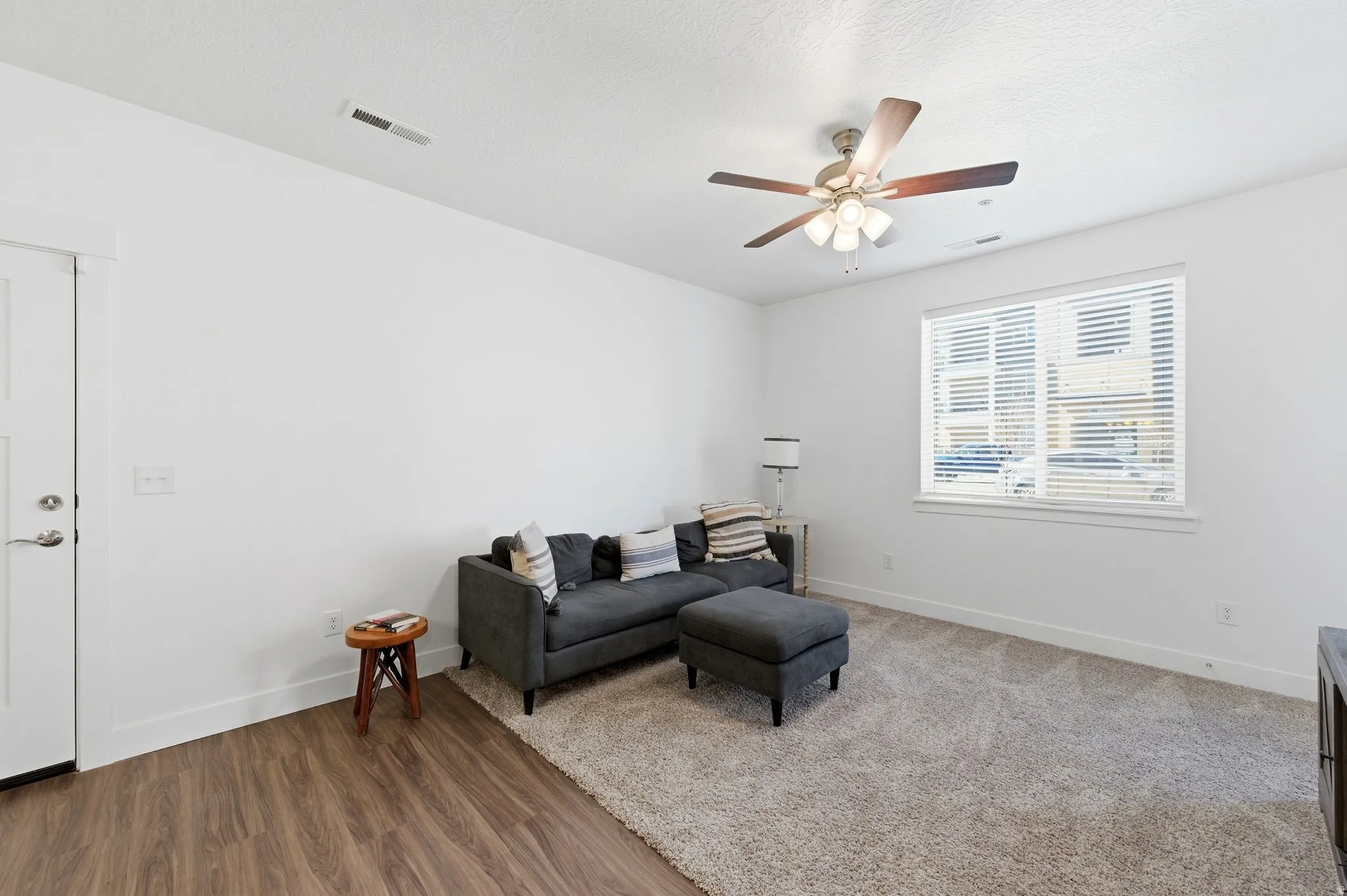 Sitting room featuring wood finished floors and a ceiling fan