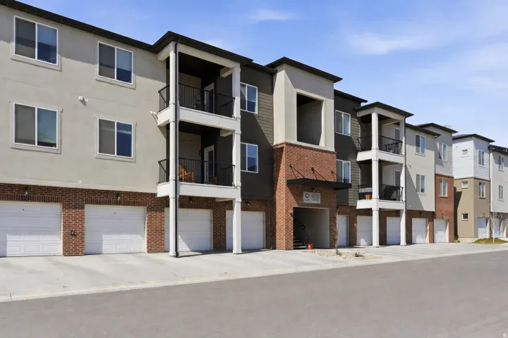View of apartment building / complex featuring a garage