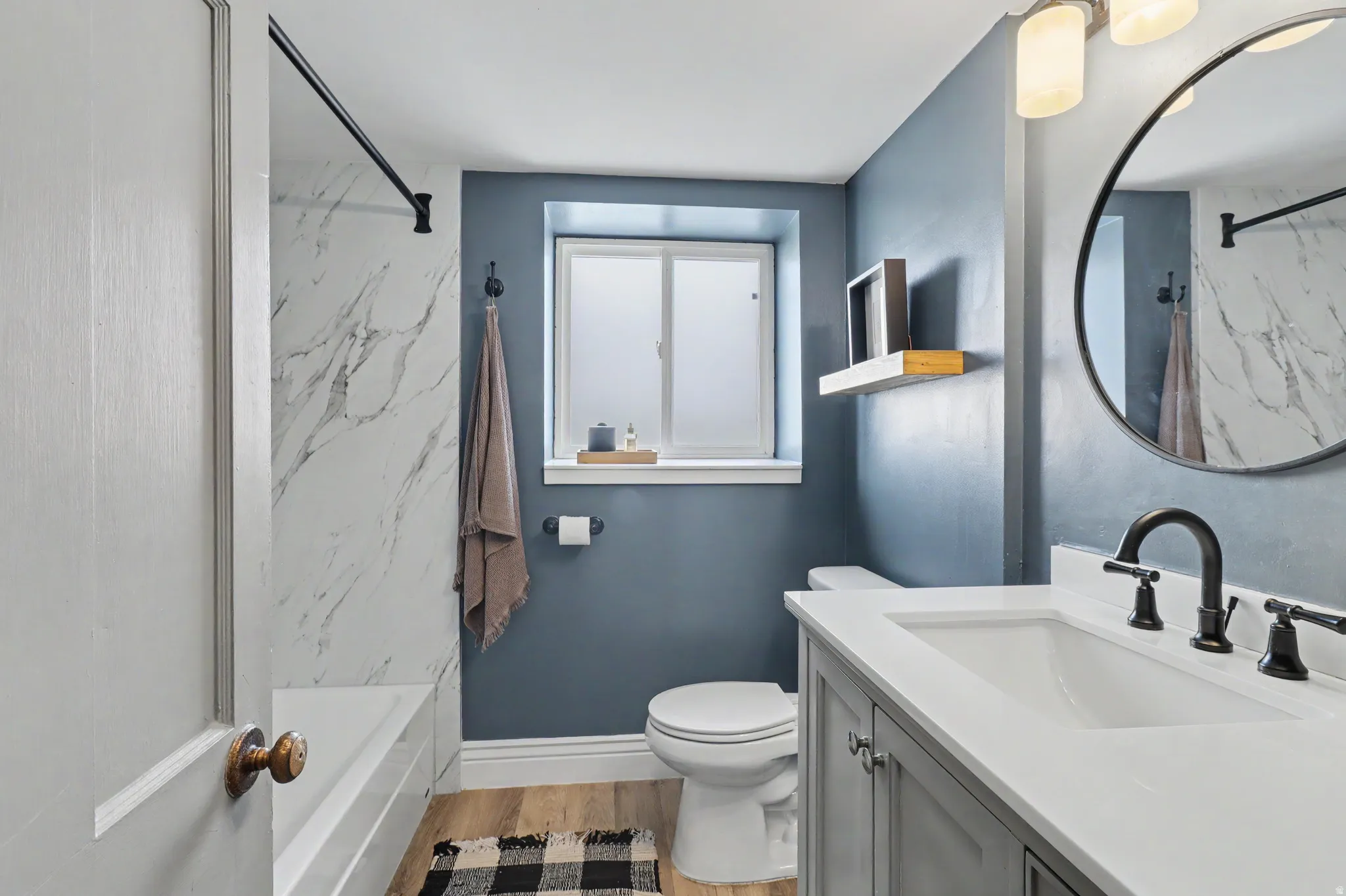 Bathroom featuring vanity and light wood-style floors