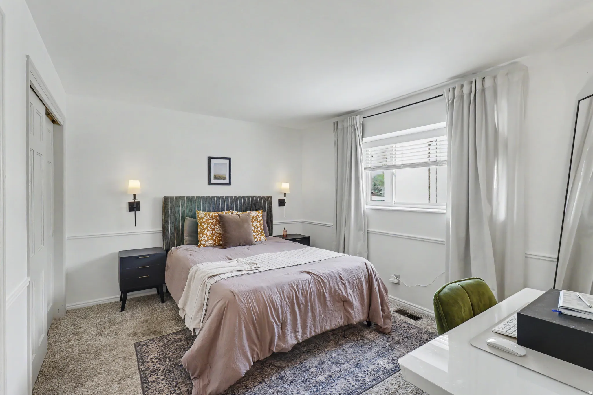 Carpeted bedroom with a closet and baseboards