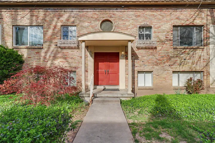 Doorway to property with brick siding