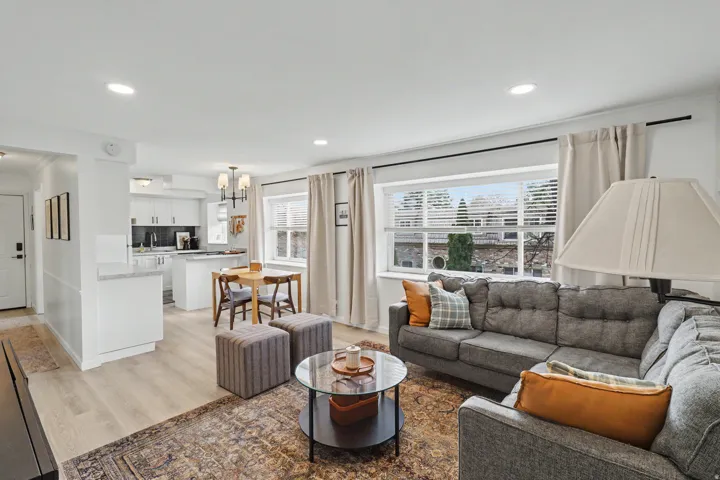 Living area with light wood-style flooring and a chandelier