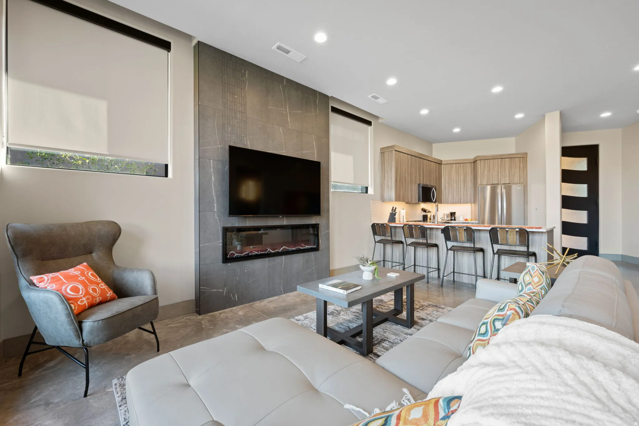 Living area featuring recessed lighting, a fireplace, and concrete floors