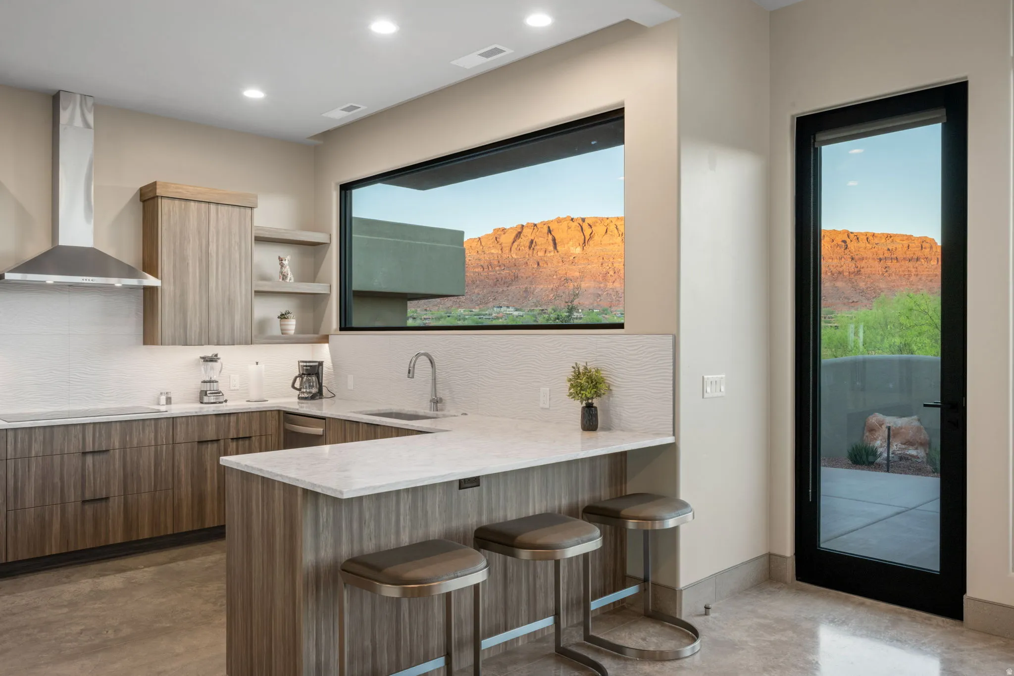 Kitchen featuring a kitchen breakfast bar, a peninsula, modern cabinets, light stone countertops, and open shelves