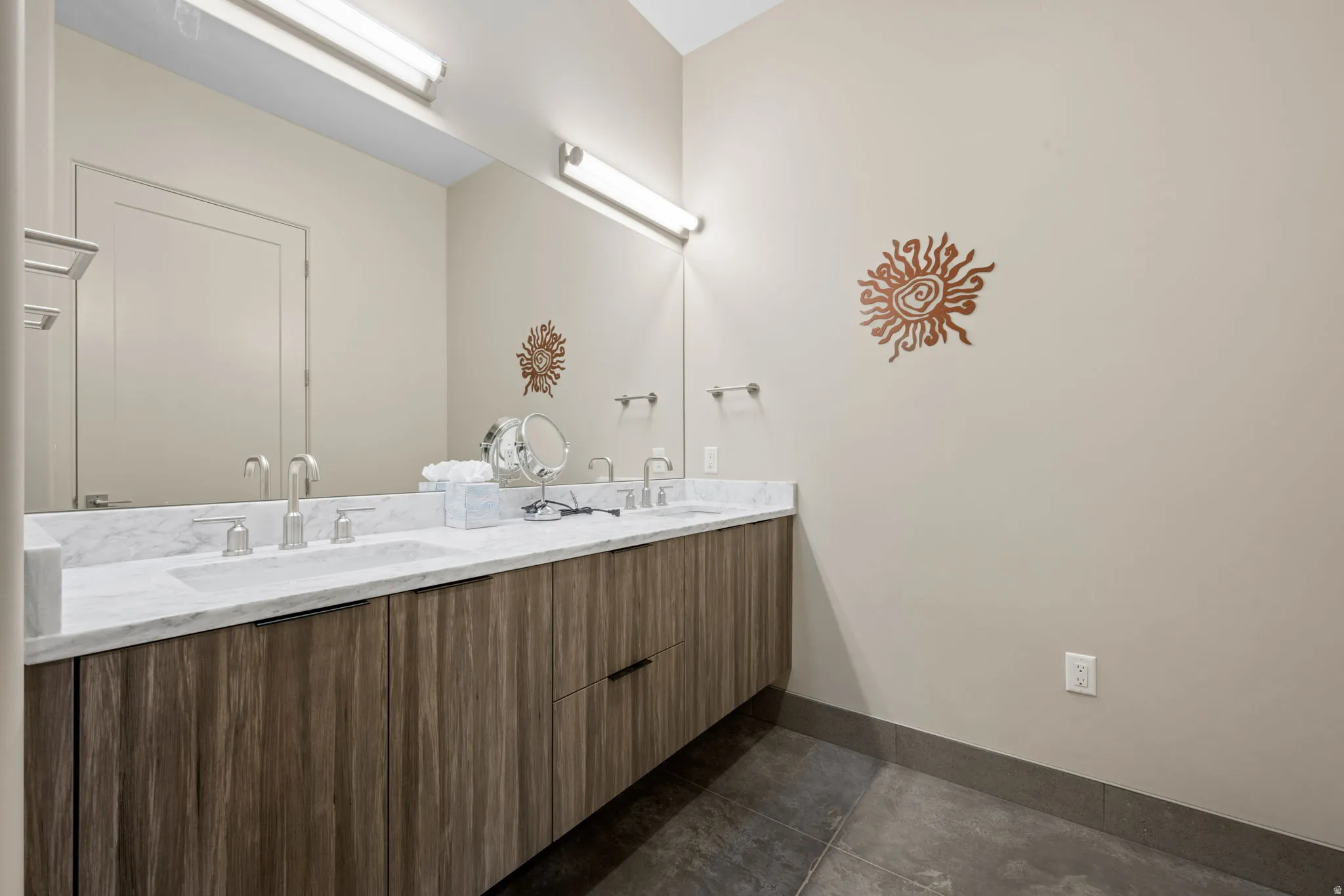 Full bath featuring double vanity and dark tile patterned flooring