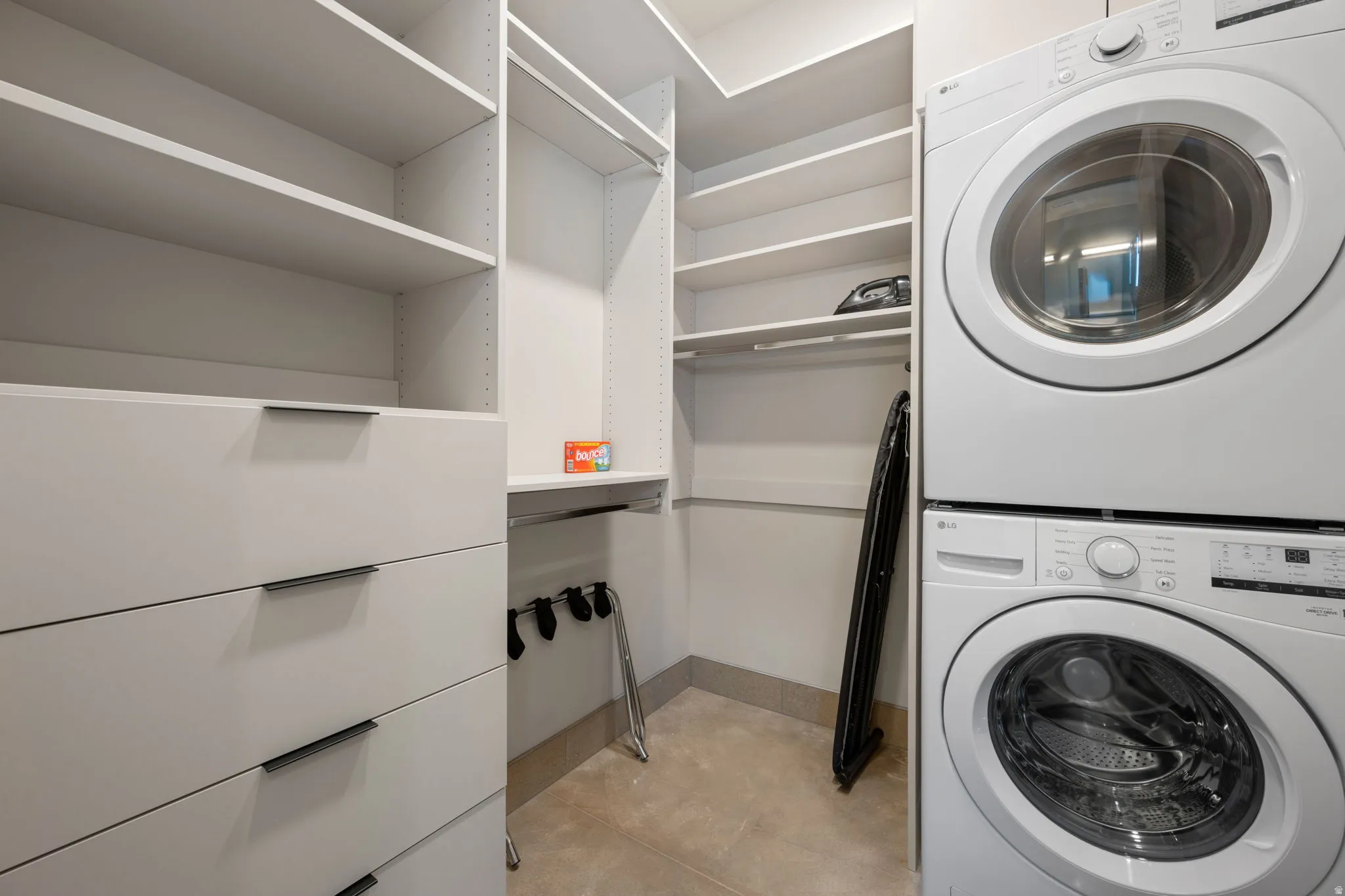 Laundry area featuring stacked washer and clothes dryer