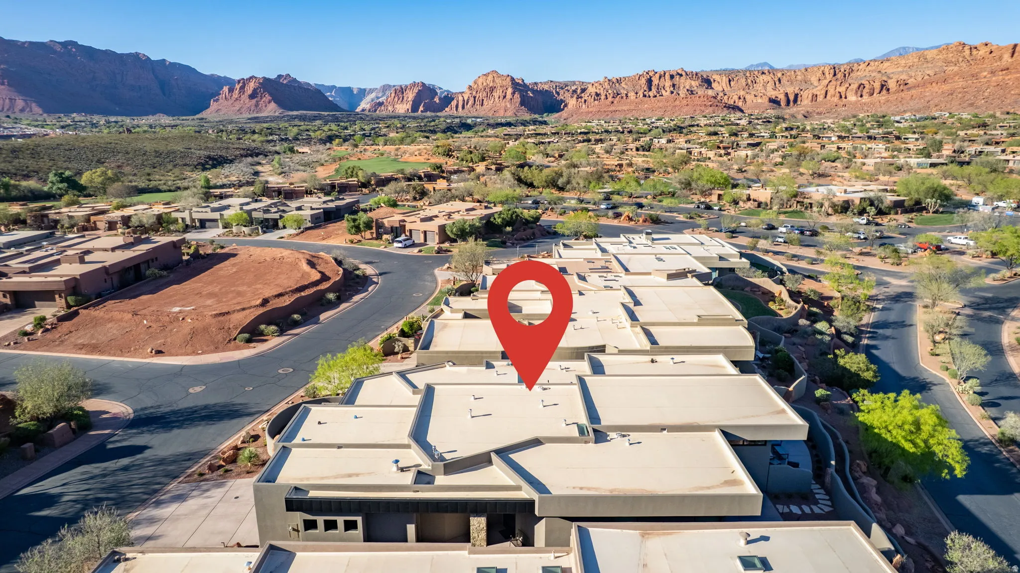 Aerial perspective of suburban area with a mountain backdrop