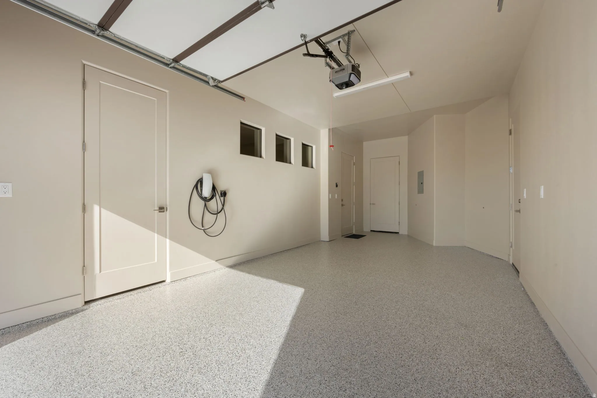 Garage featuring car charger and a garage door opener