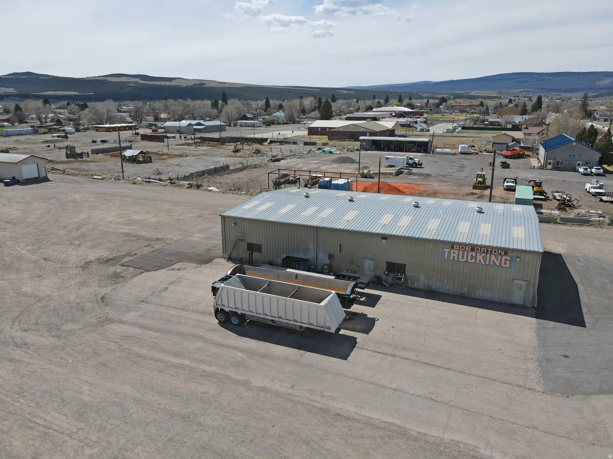 Bird's eye view of industrial structures and mountains