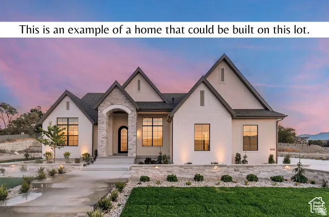 View of front of home with a front lawn, stucco siding, and brick siding