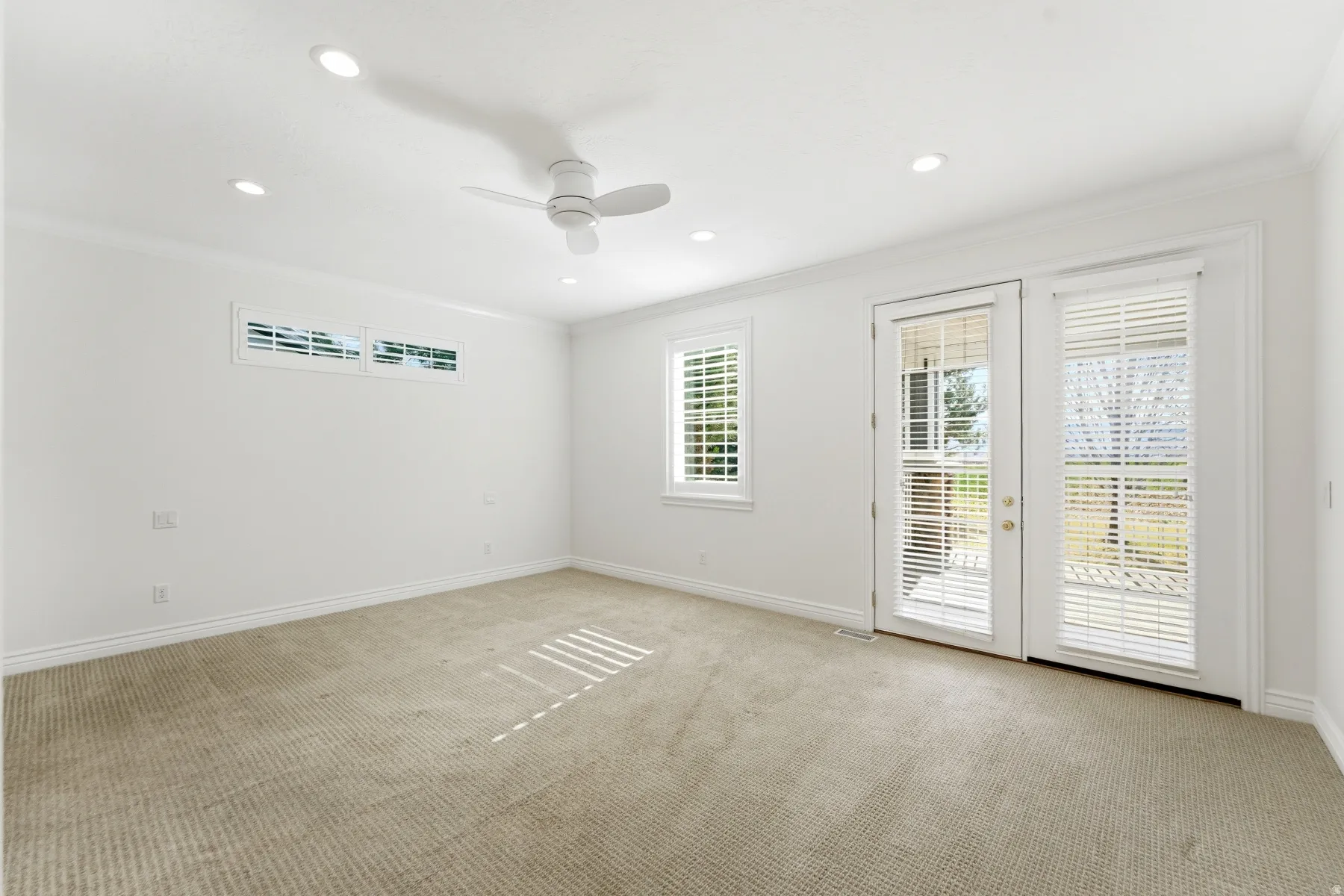 Primary Bedroom with private entrance to the enclosed patio.
