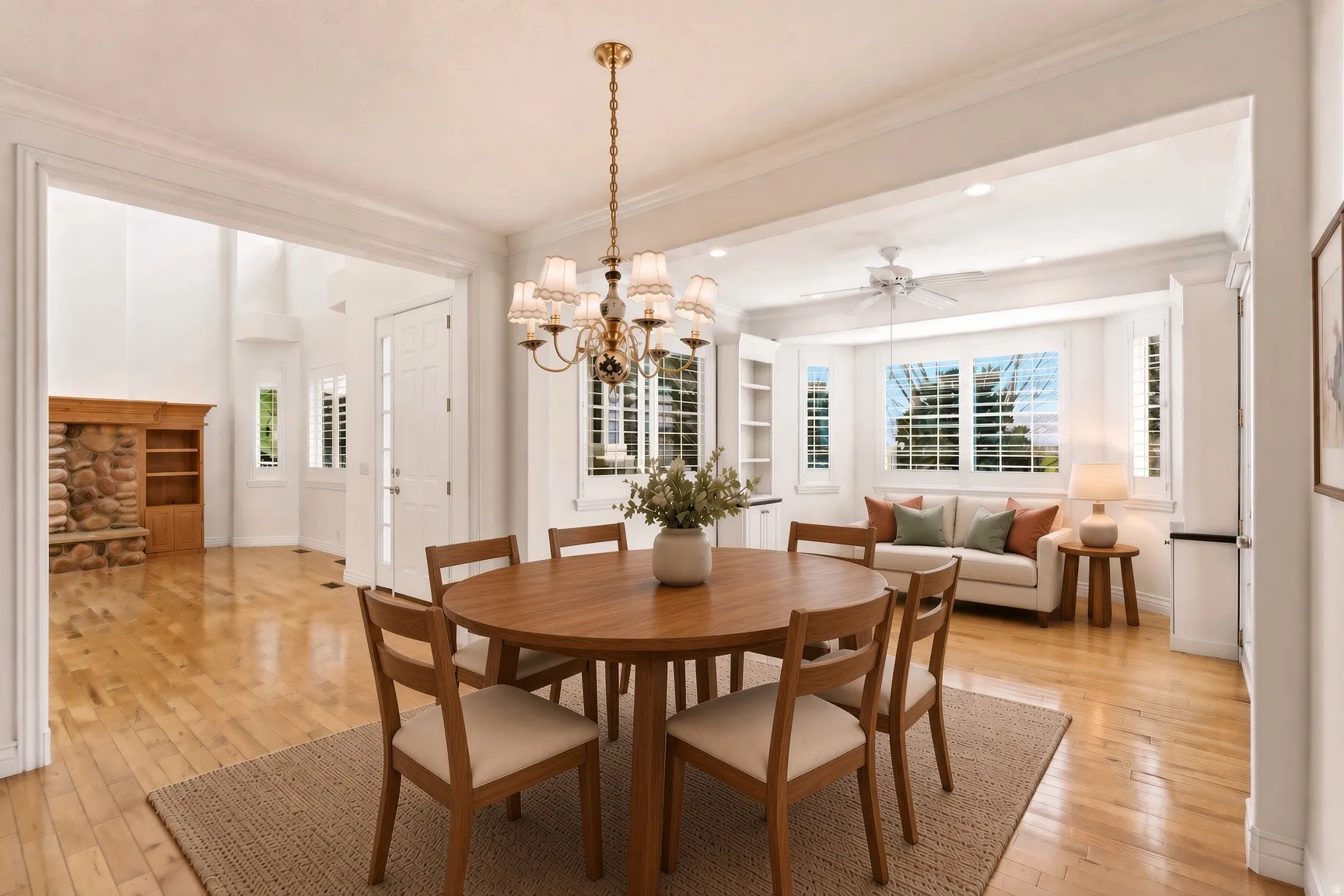 Hardwood flooring, cased openings, recessed lighting, white wood window shutters, and a brass-finish chandelier