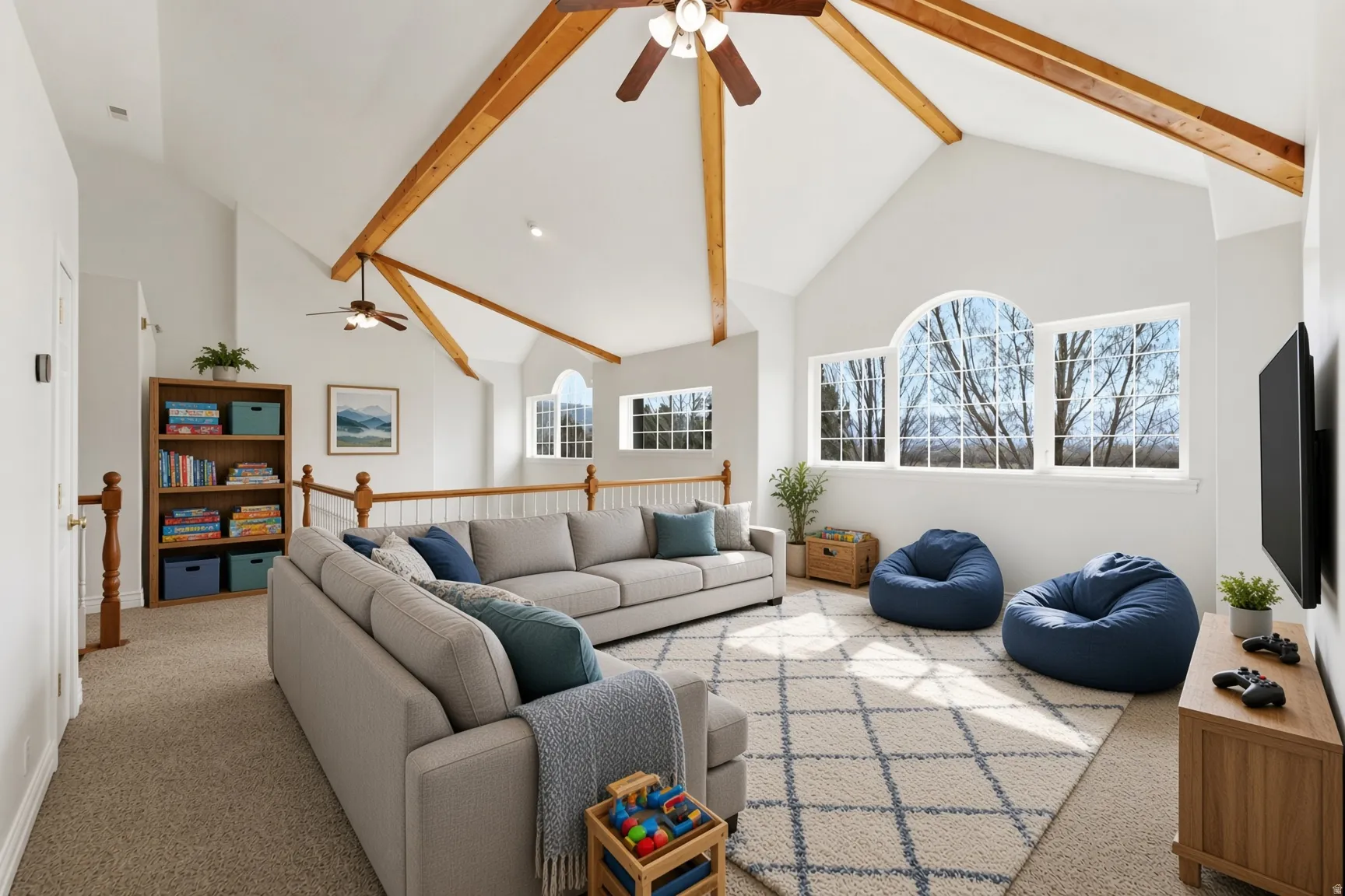 Vaulted white ceilings with exposed wood beams, multiple ceiling fans, and large arched and rectangular windows