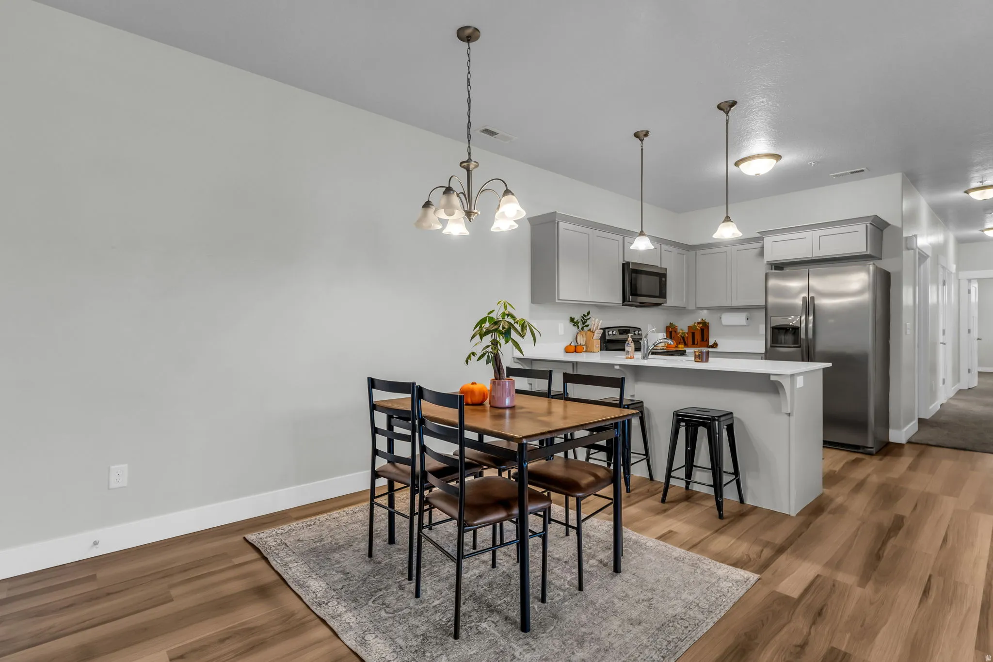 Dining area featuring light wood finished floors and hanging lights