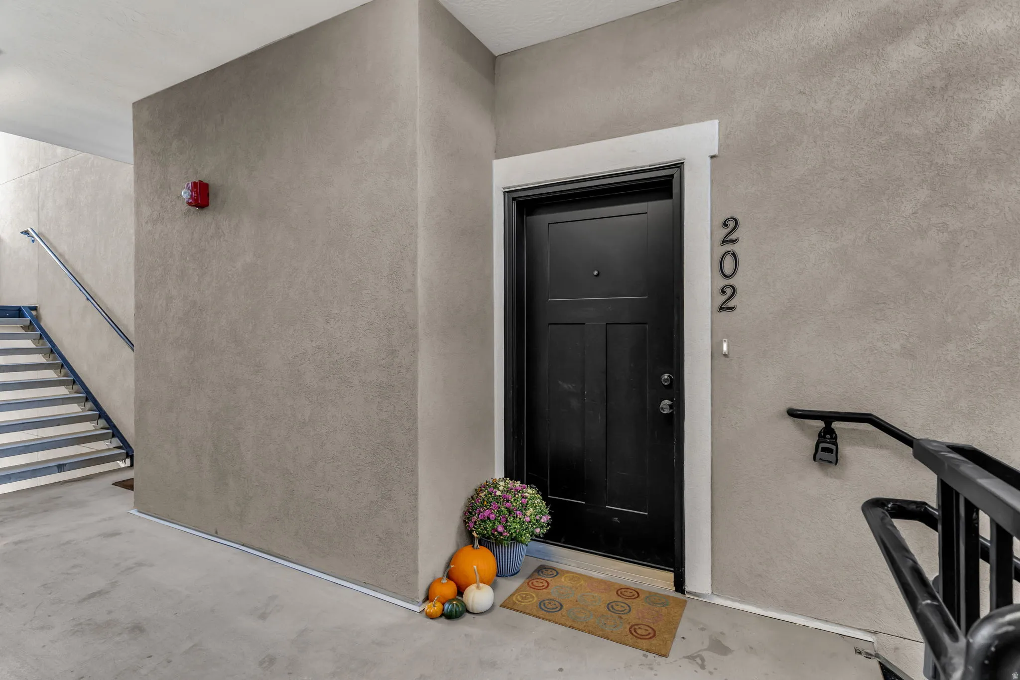 Doorway to property with stucco siding