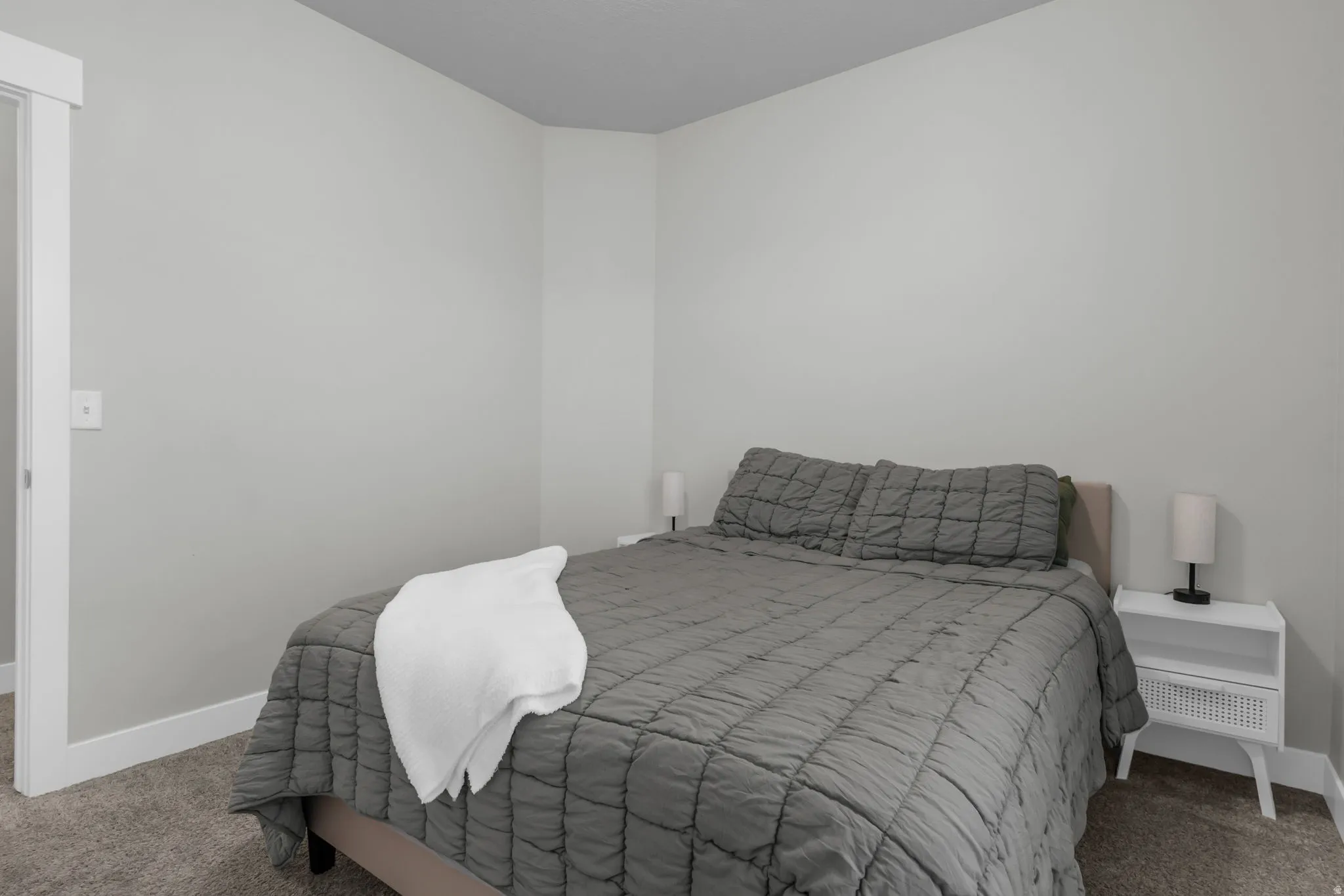 Bedroom featuring carpet and baseboards