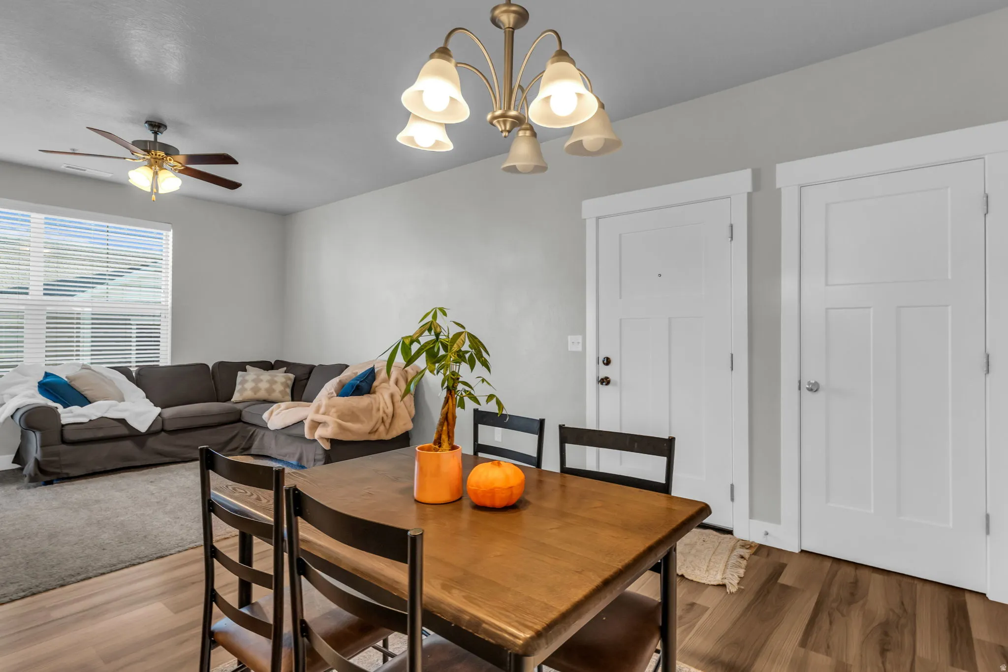 Dining area with wood finished floors, suspended lighting, and ceiling fan