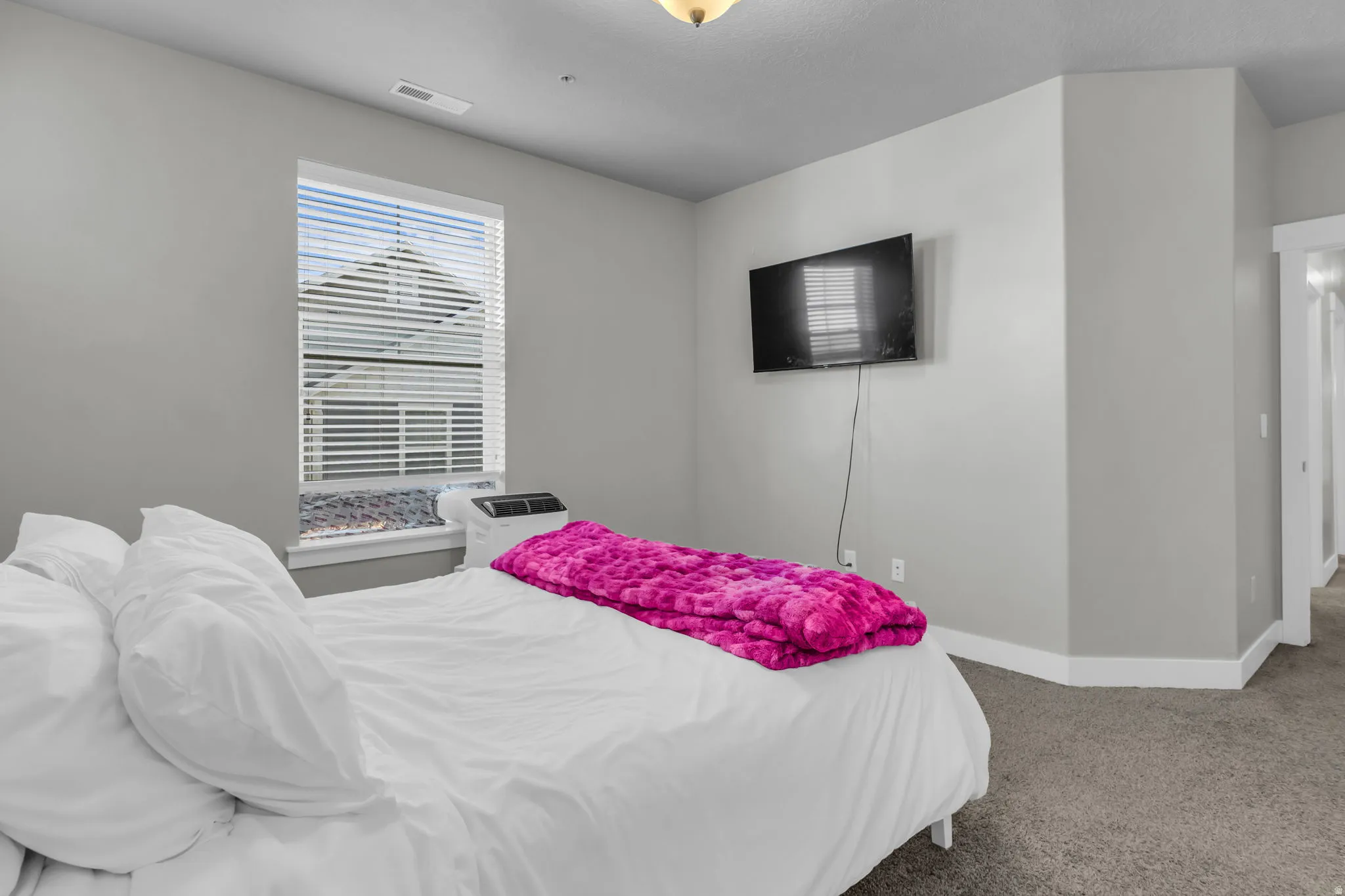 Bedroom featuring carpet and baseboards