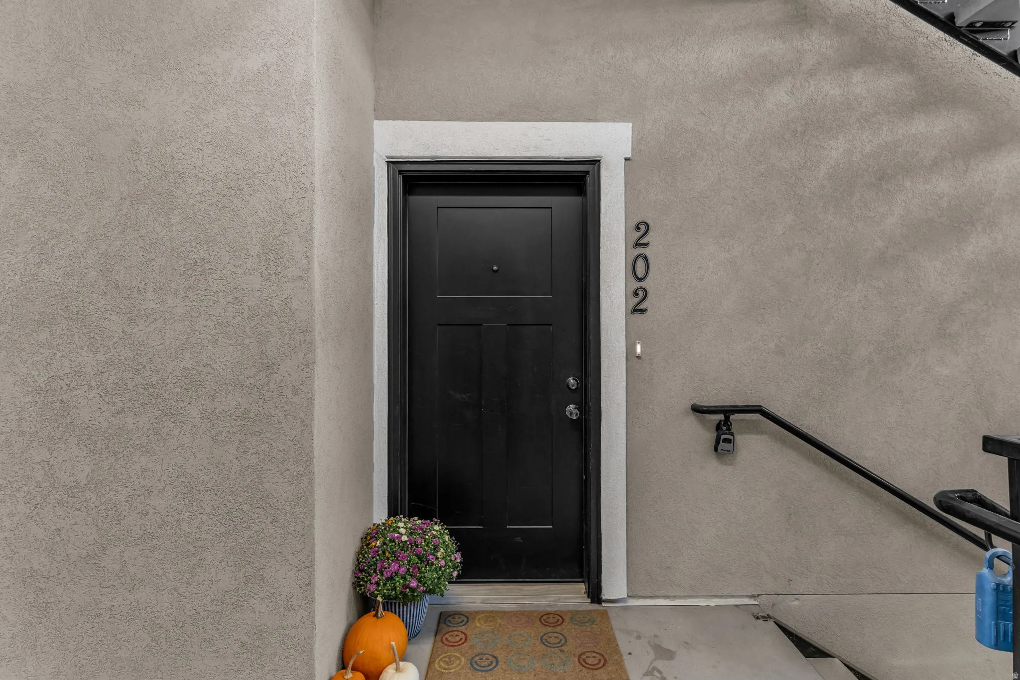 Entrance to property with stucco siding