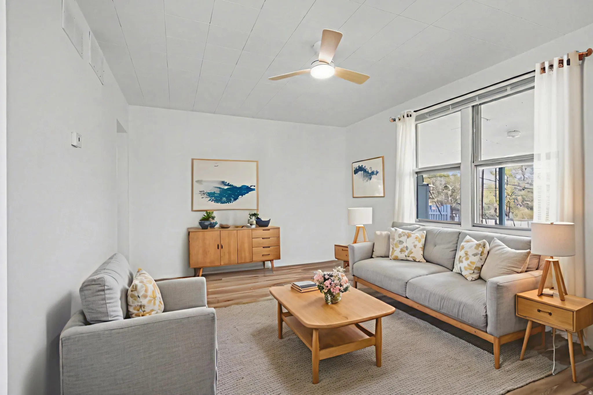 Living Room virtually staged facing windows to the covered patio