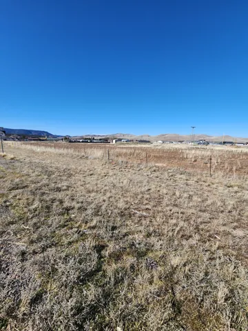 View of yard featuring a view of rural / pastoral area and a mountain view
