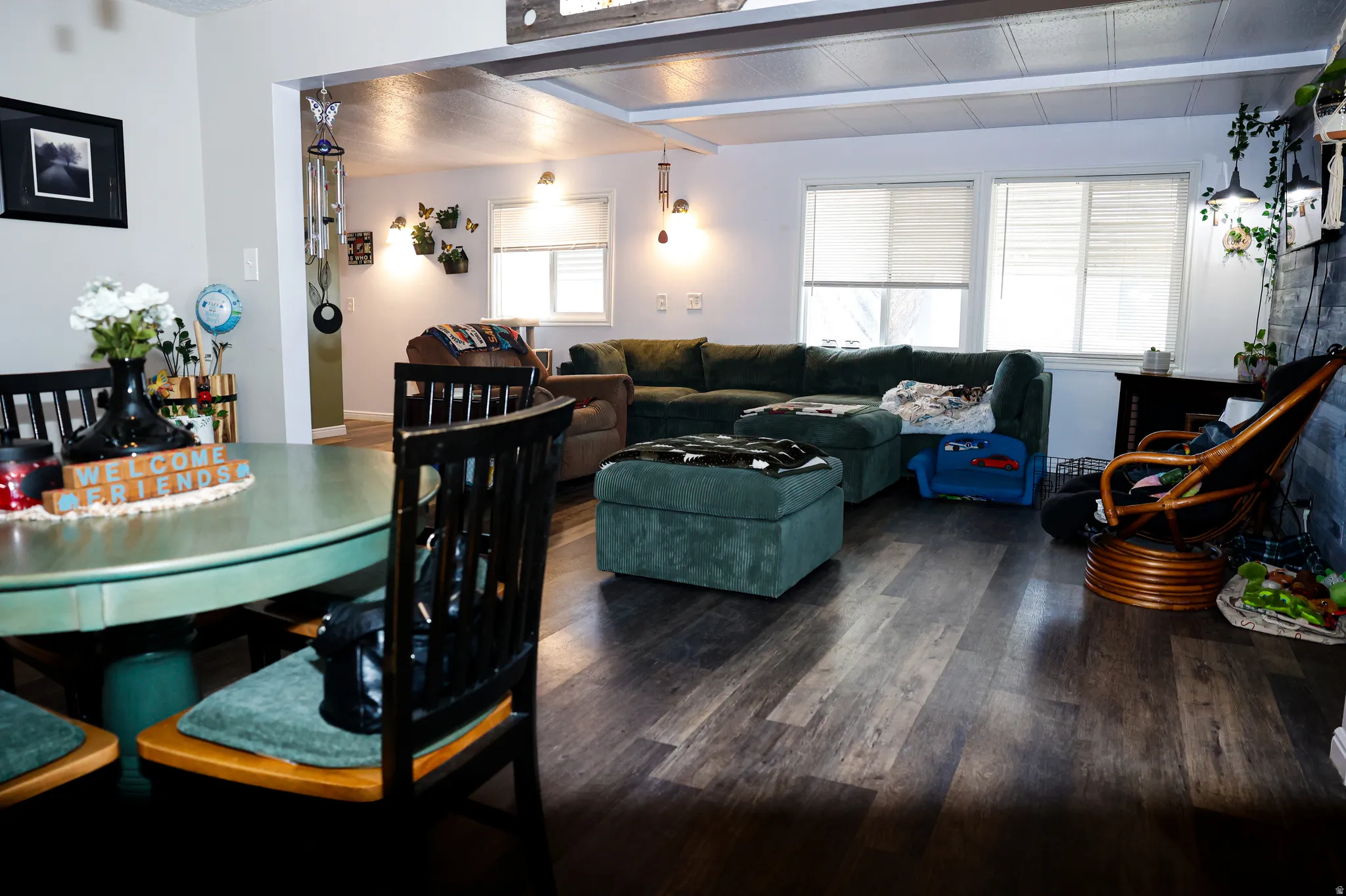 Dining space with wood finished floors and beamed ceiling