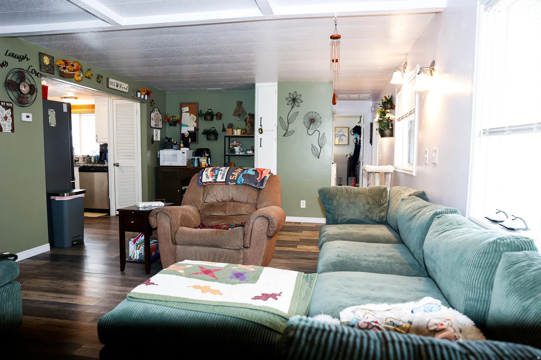 Living area featuring dark wood-type flooring and baseboards