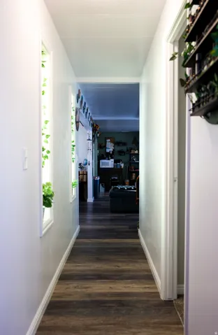 Hall with dark wood-type flooring