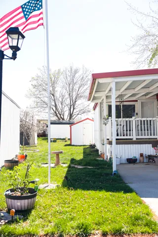 View of grassy yard with a storage unit