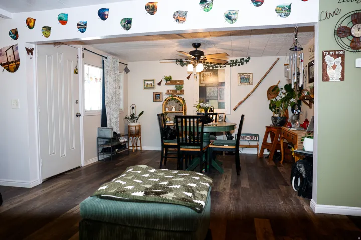 Dining area with dark wood-type flooring and a ceiling fan