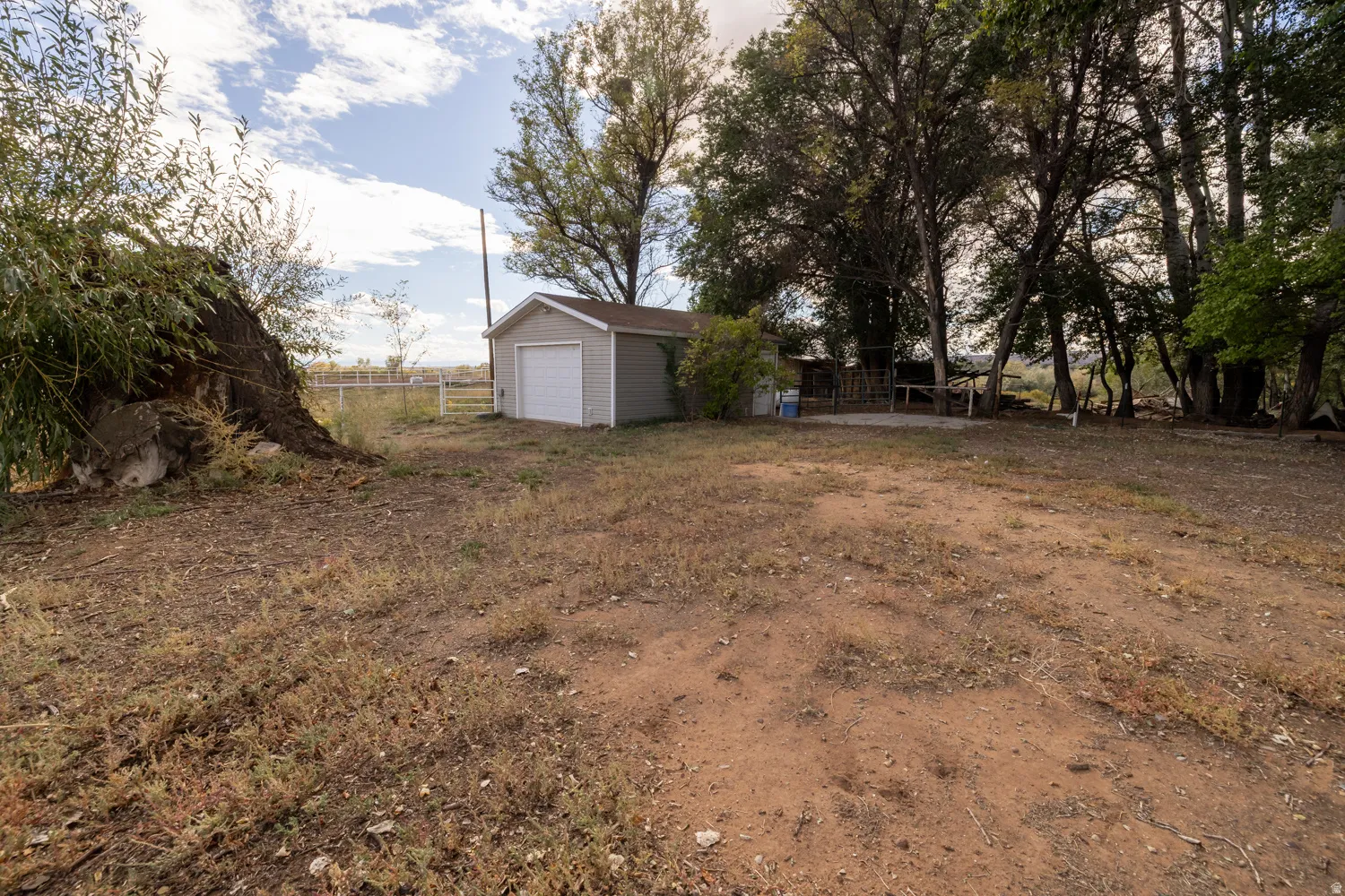 View of yard featuring an outdoor structure and a patio area