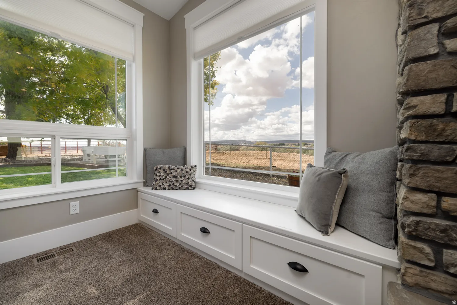 Living area featuring baseboards and dark carpet