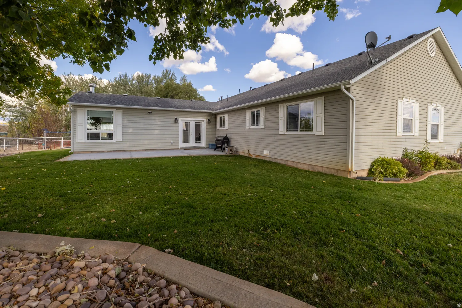 Rear view of house with a patio and french doors