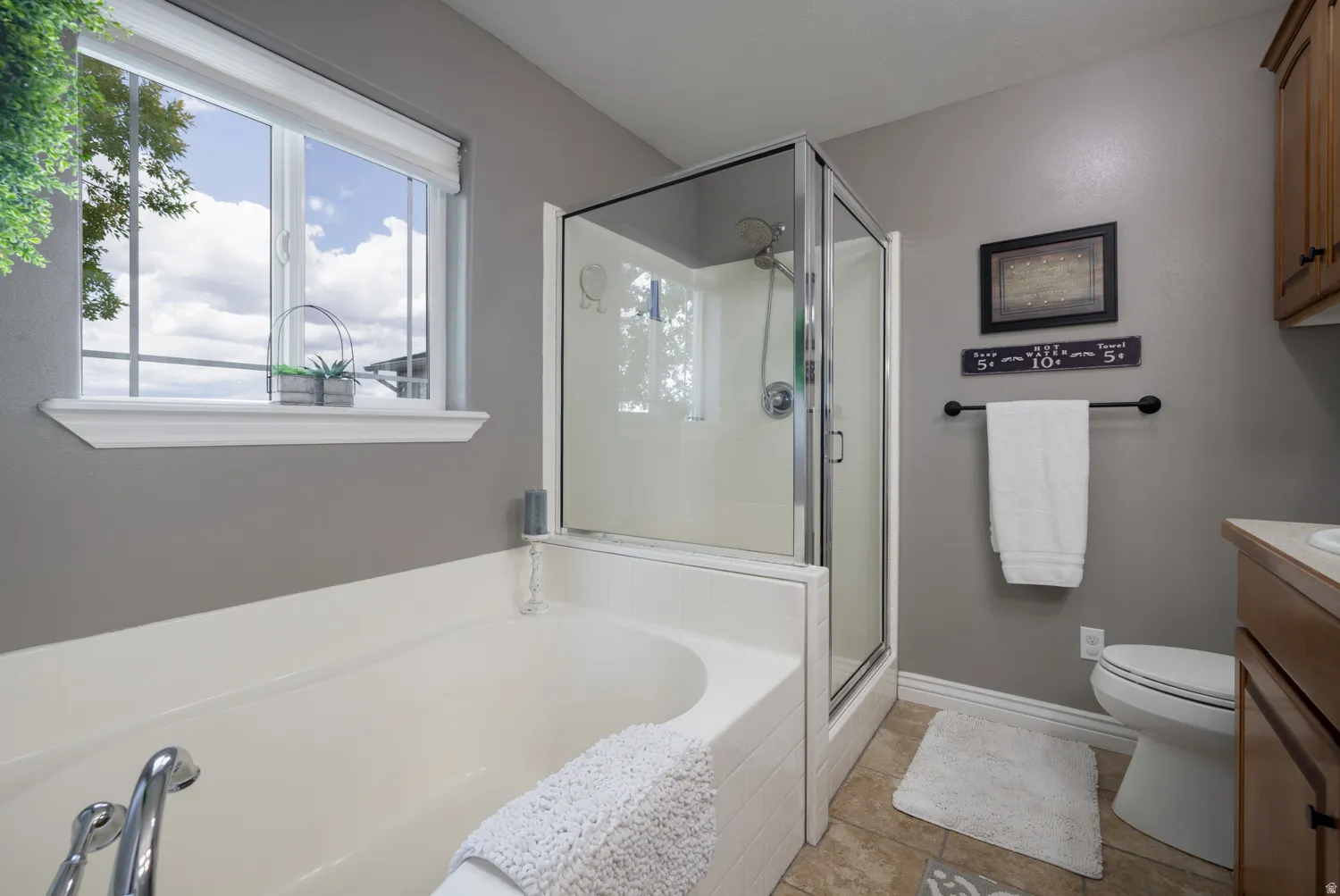 Bathroom with vanity, a stall shower, light tile patterned floors, and a bath