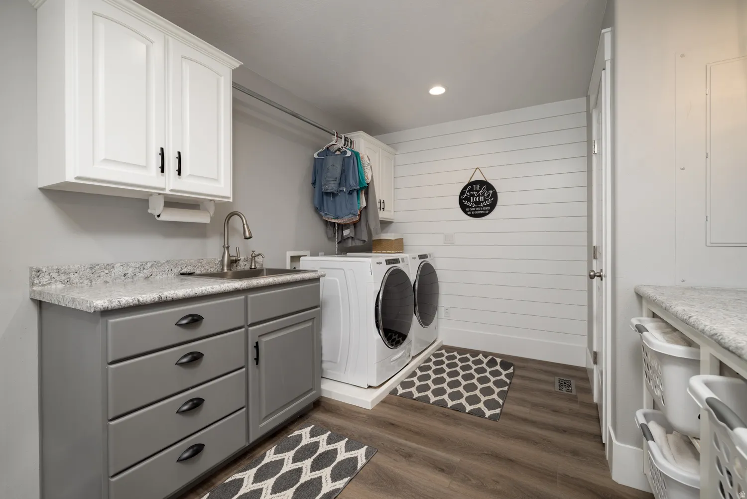 Laundry room featuring dark wood-style floors, washer and dryer, recessed lighting, and cabinet space