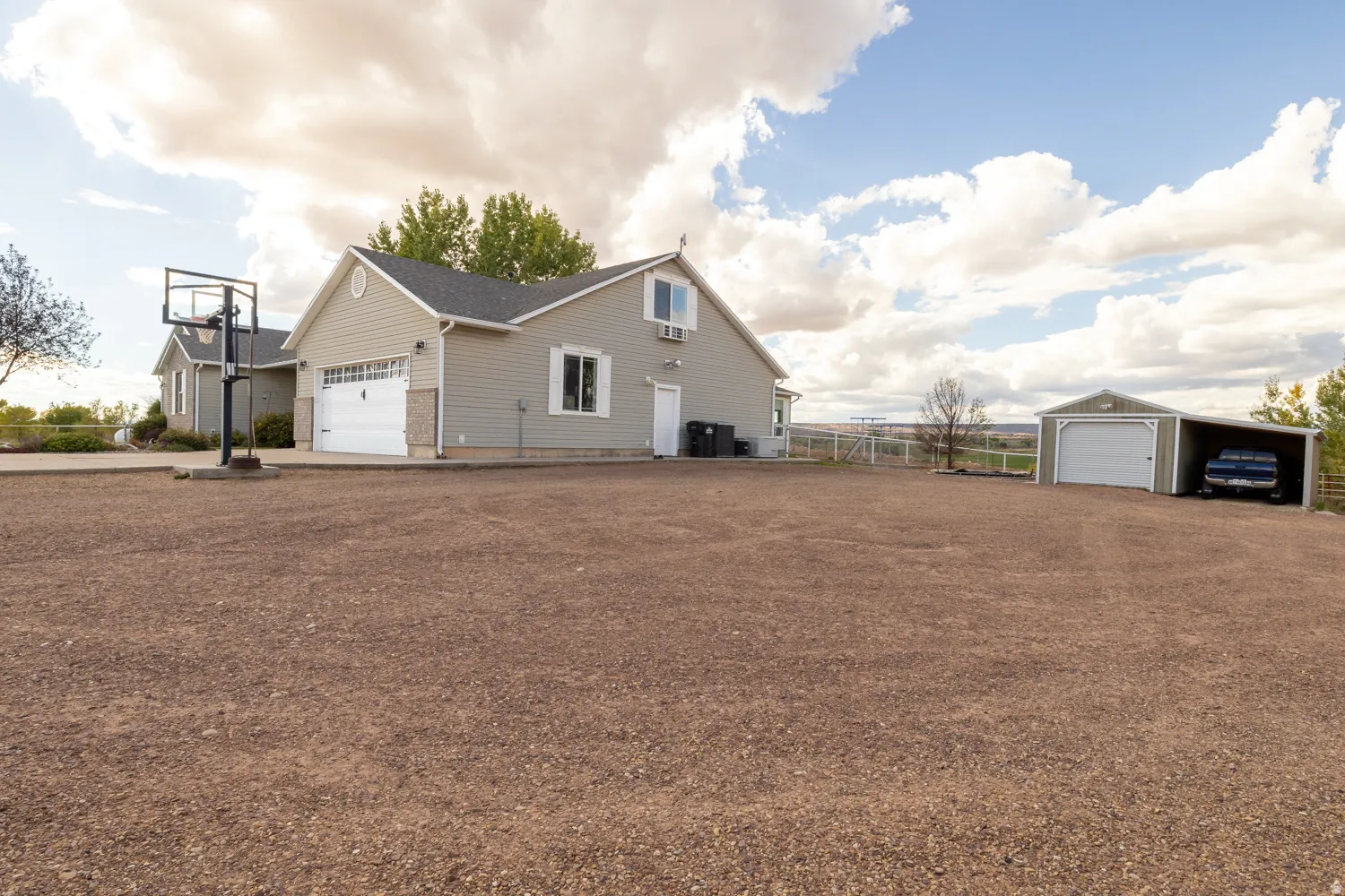 View of property exterior featuring a detached garage and an outdoor structure